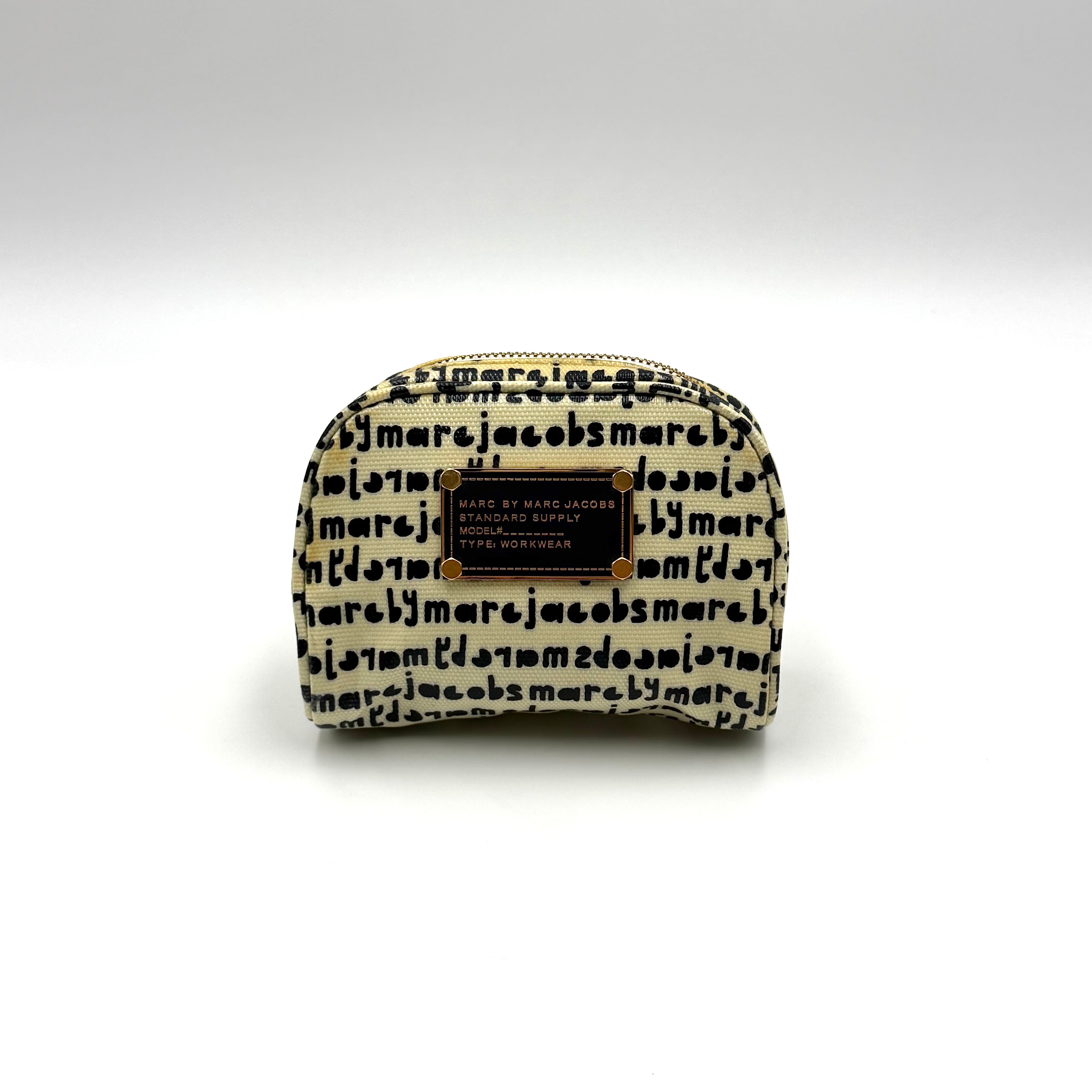 Marc Jacobs dome-shaped cosmetic case in cream coated canvas with navy script and gold hardware.