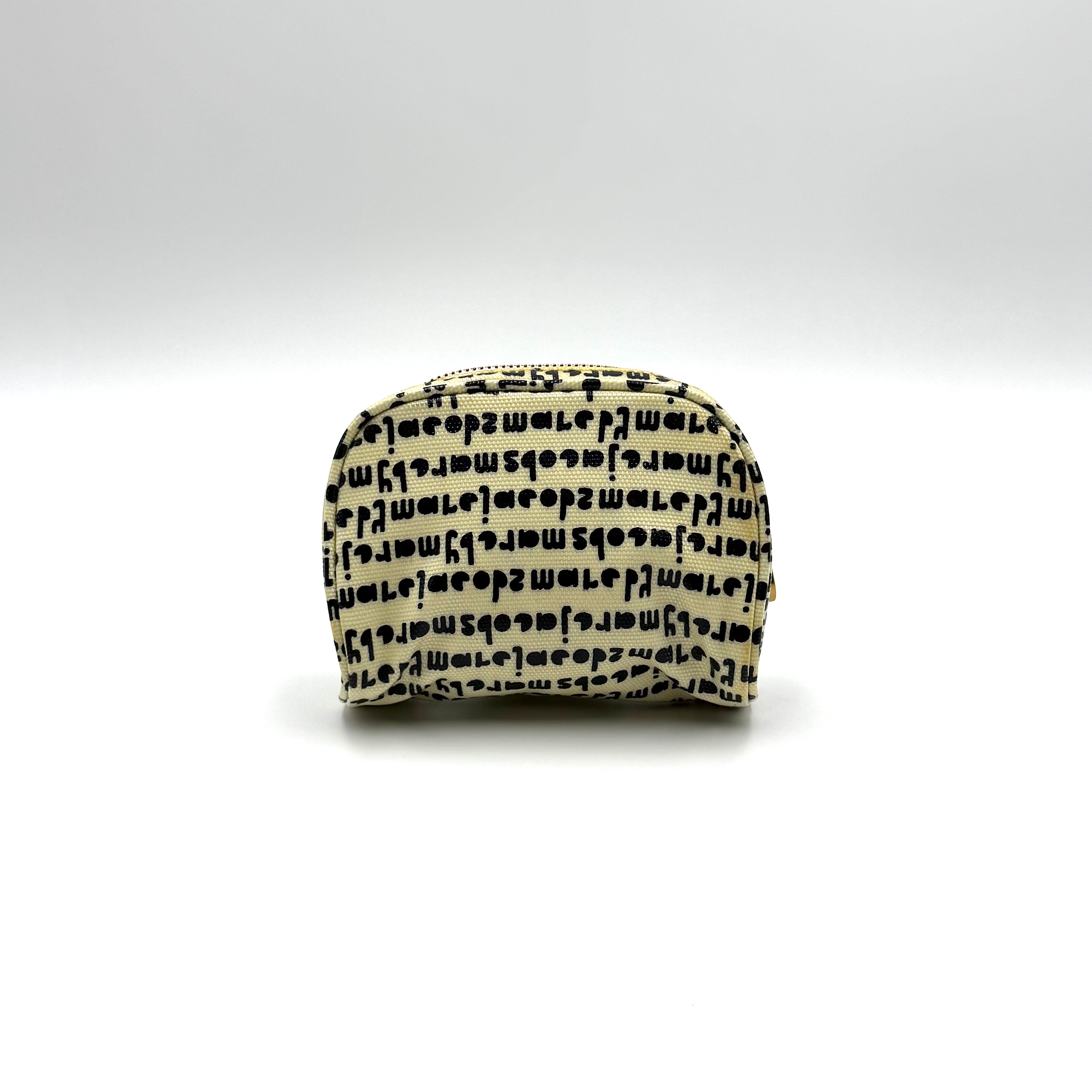 Marc Jacobs dome-shaped cosmetic case in cream coated canvas with navy script and gold hardware.
