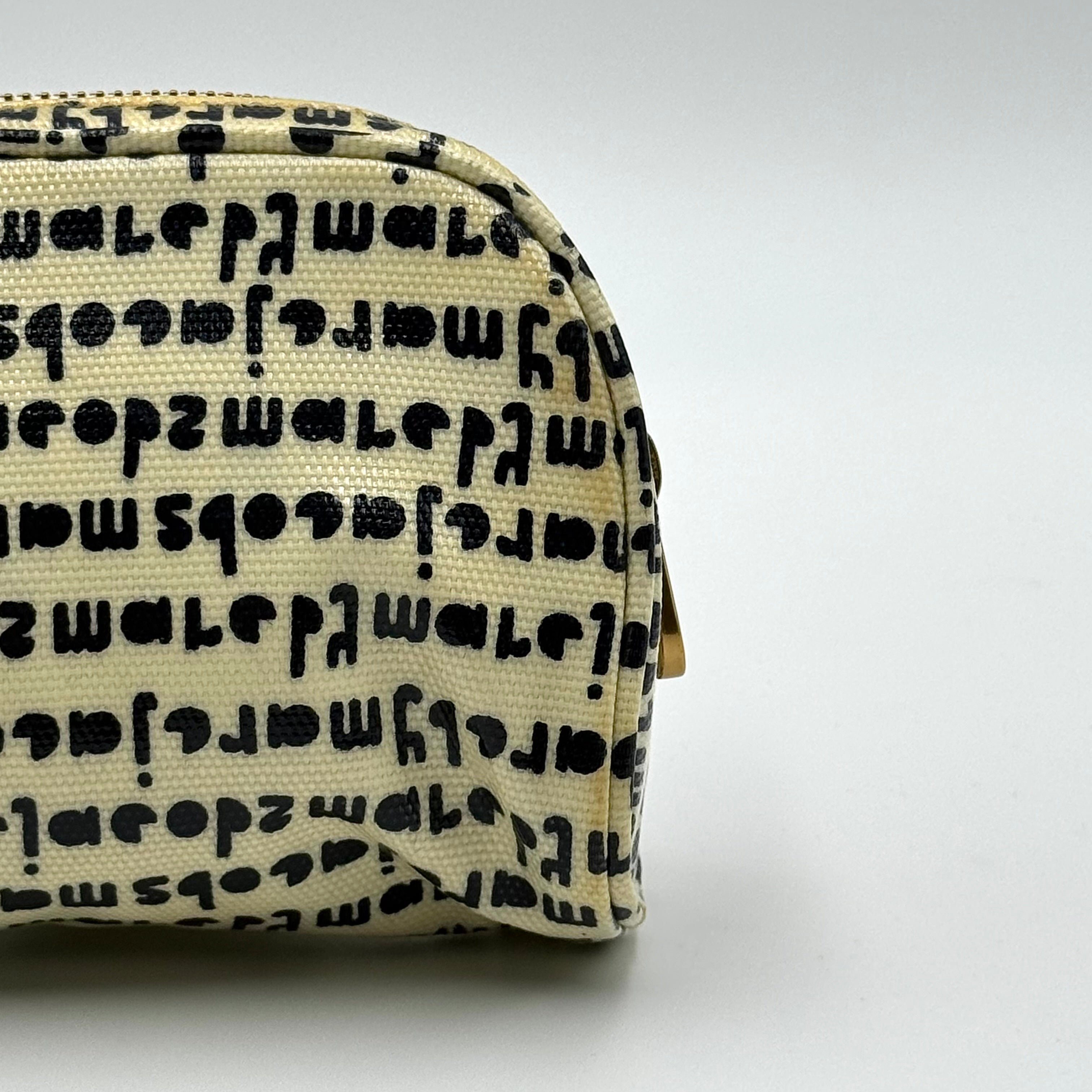 Marc Jacobs dome-shaped cosmetic case in cream coated canvas with navy script and gold hardware.