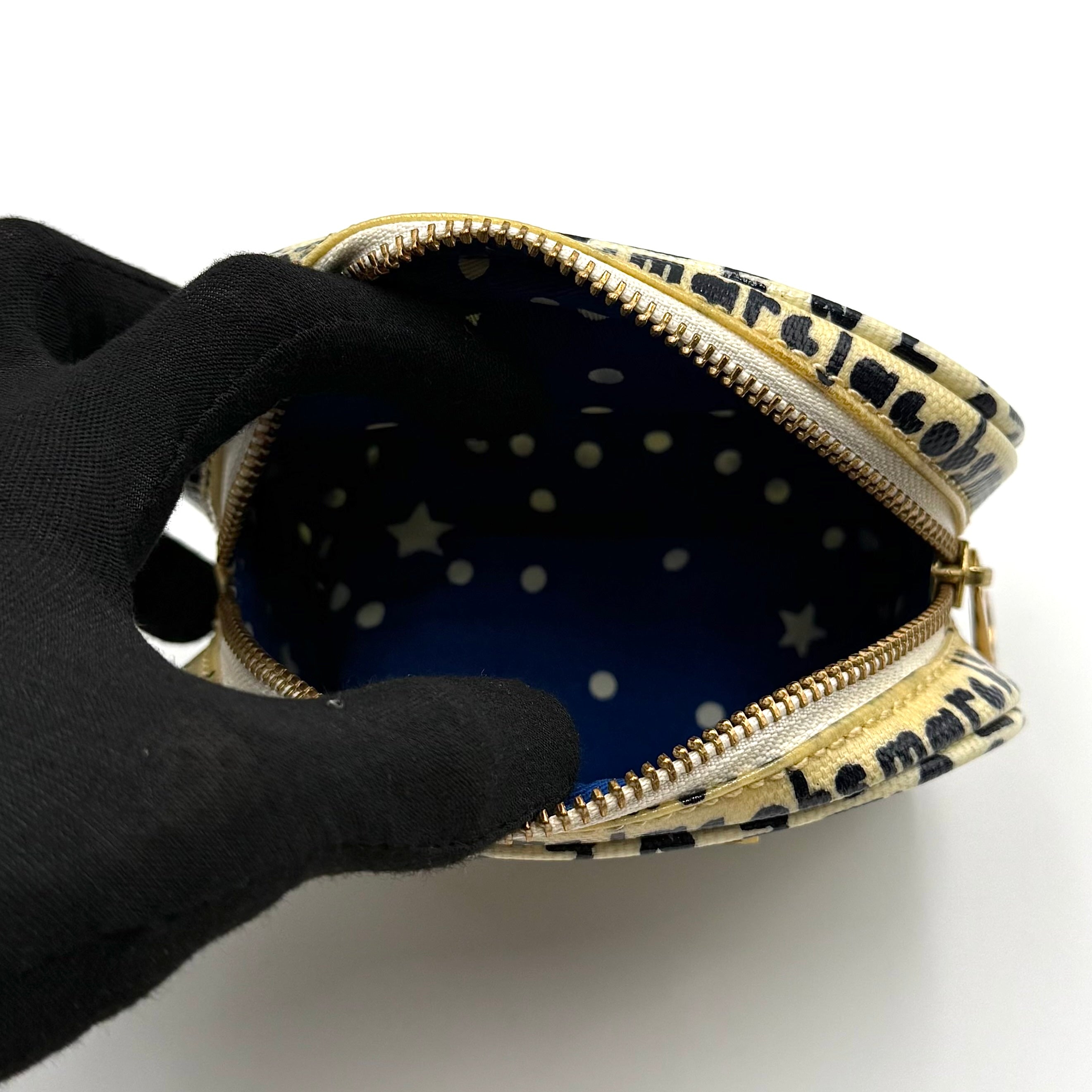 Marc Jacobs dome-shaped cosmetic case in cream coated canvas with navy script and gold hardware.