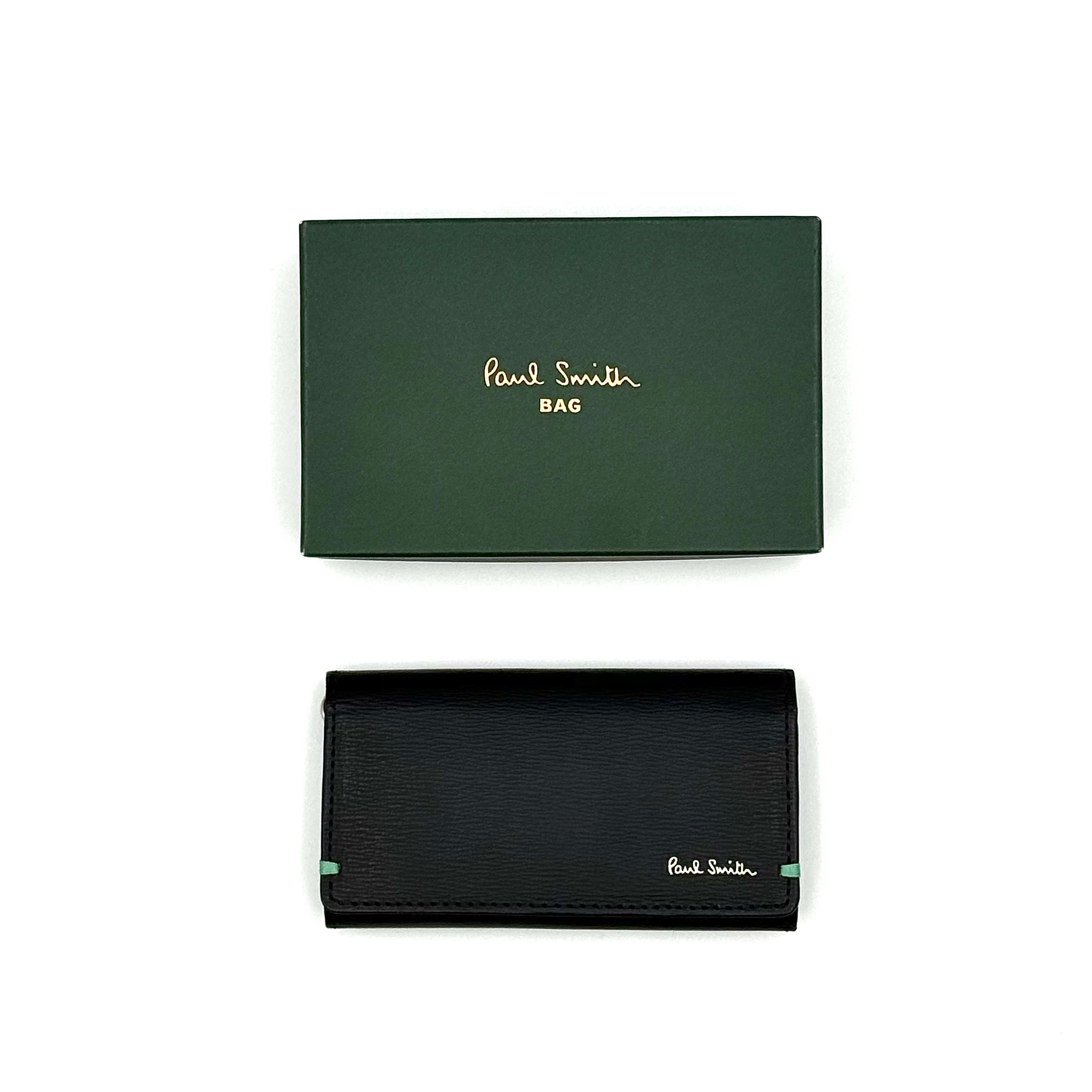 Paul Smith key case in grained black leather with Tiffany blue accents and silver logo, displayed on a white background.