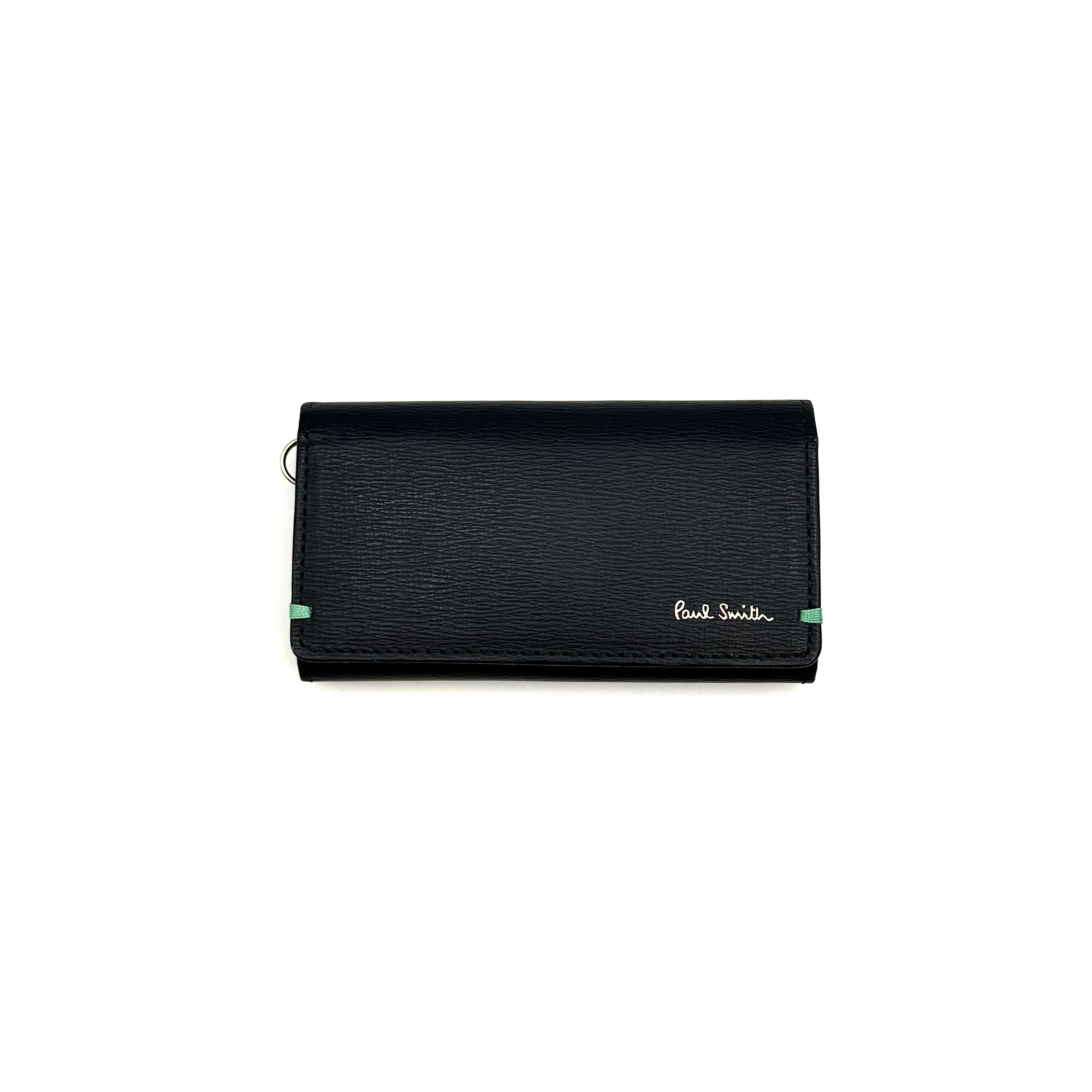 Paul Smith key case in grained black leather with Tiffany blue accents and silver logo, displayed on a white background.