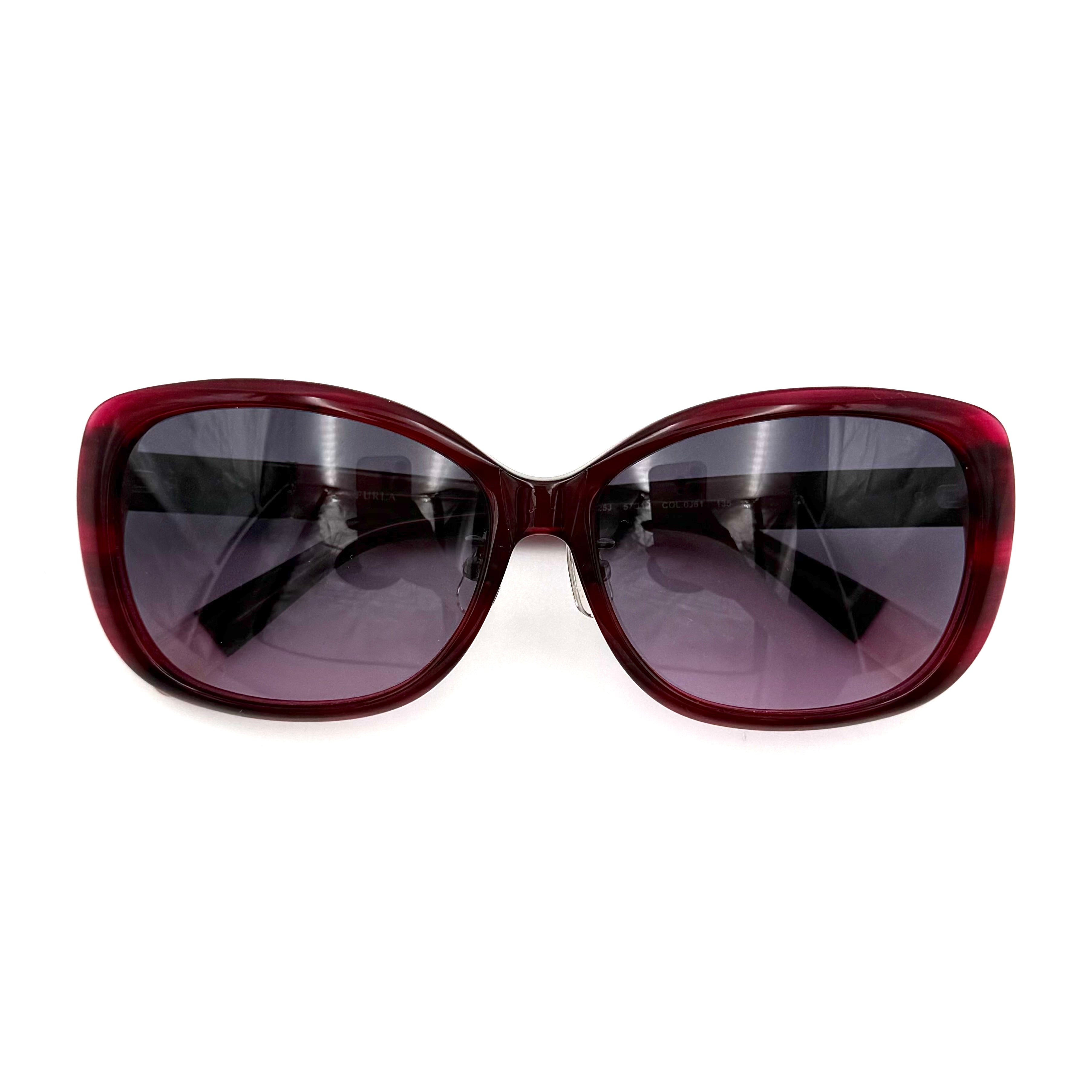 Furla SU4925J sunglasses in dark red acetate with butterfly-shaped frames, silver-tone hardware, and gradient lenses, presented alongside a Furla hard case.