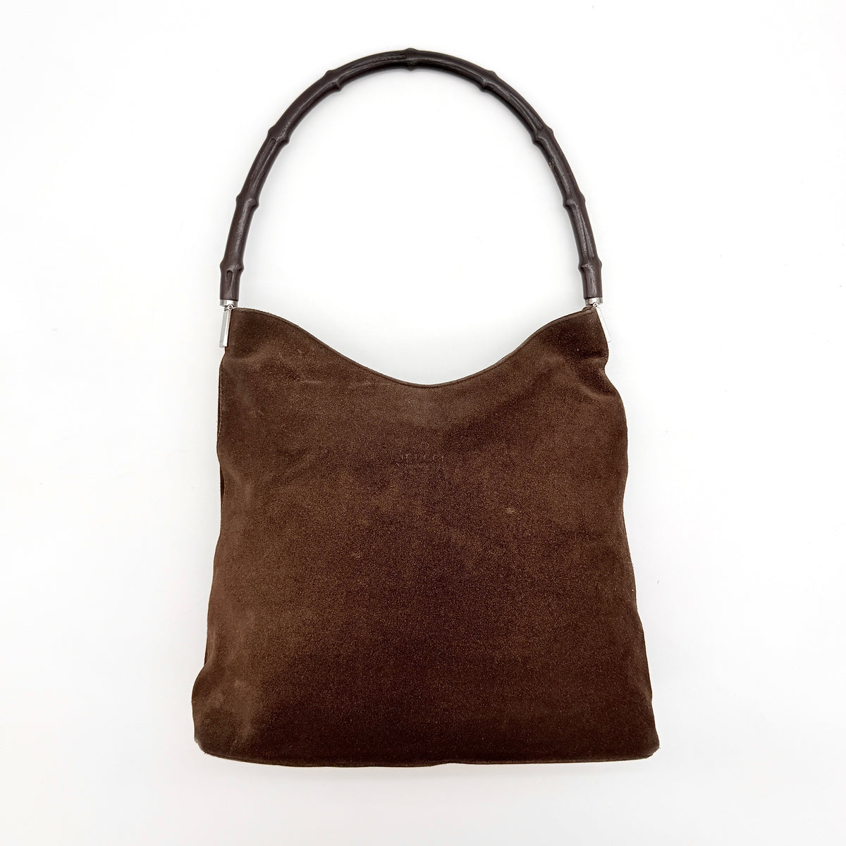 Gucci Bamboo Shoulder Bag in brown suede with a sculpted bamboo handle, photographed on a white background.