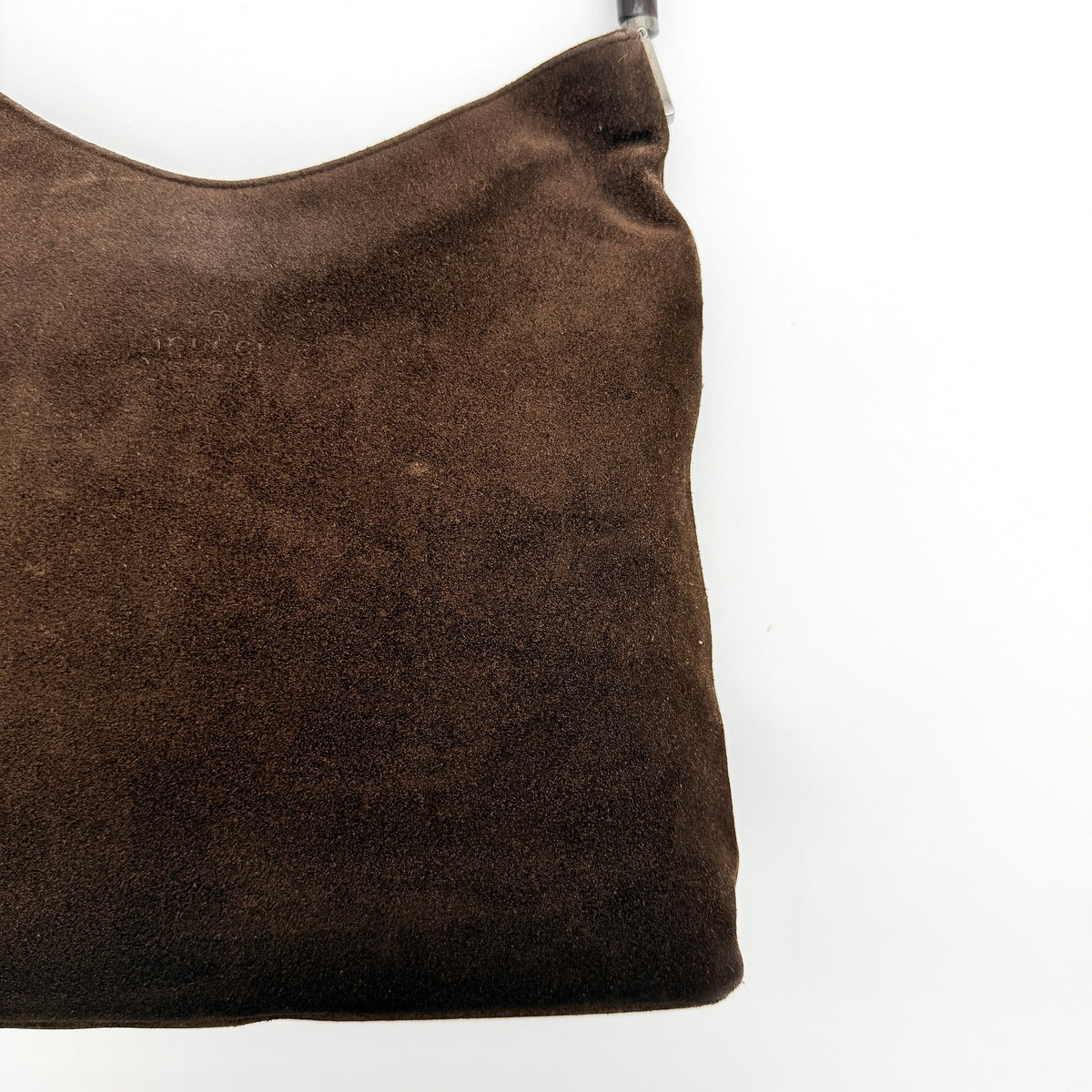 Gucci Bamboo Shoulder Bag in brown suede with a sculpted bamboo handle, photographed on a white background.