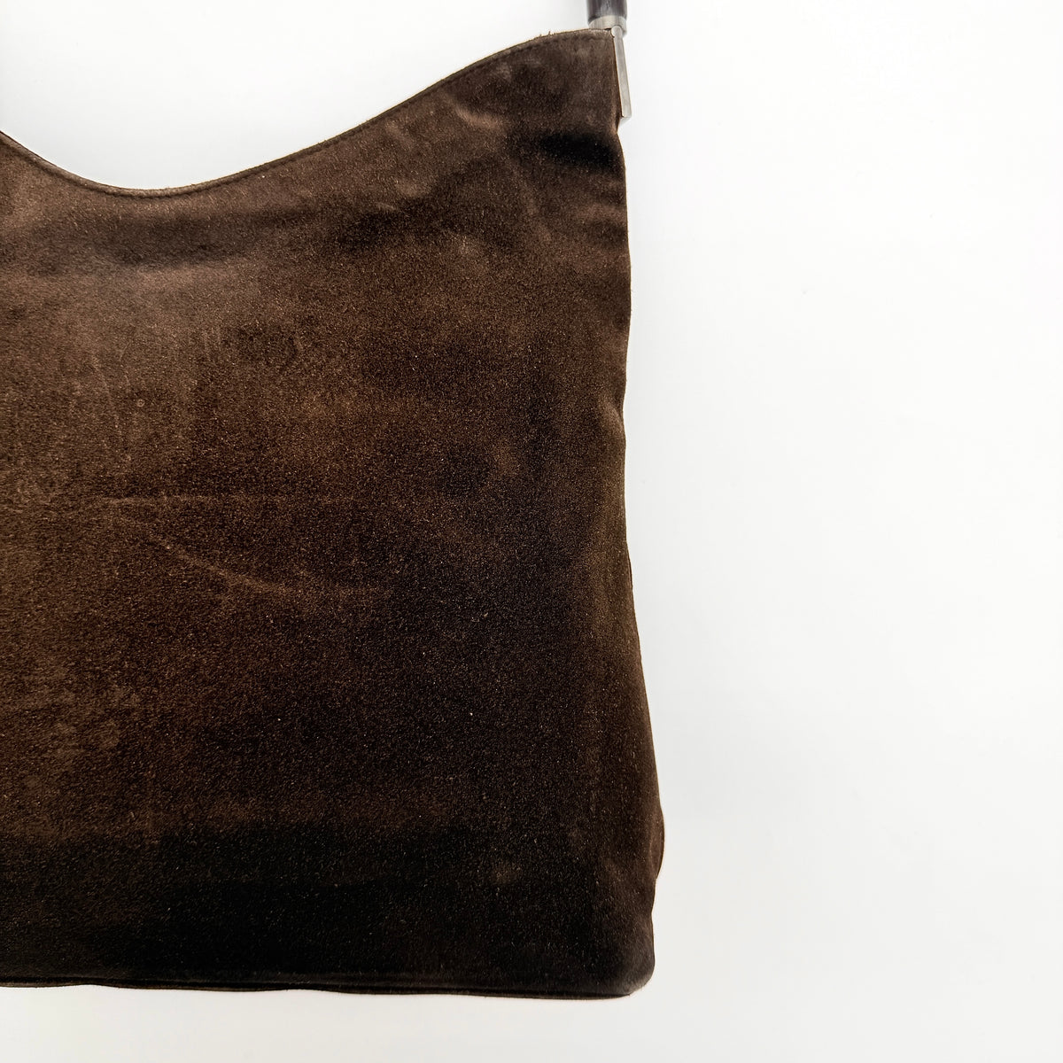 Gucci Bamboo Shoulder Bag in brown suede with a sculpted bamboo handle, photographed on a white background.
