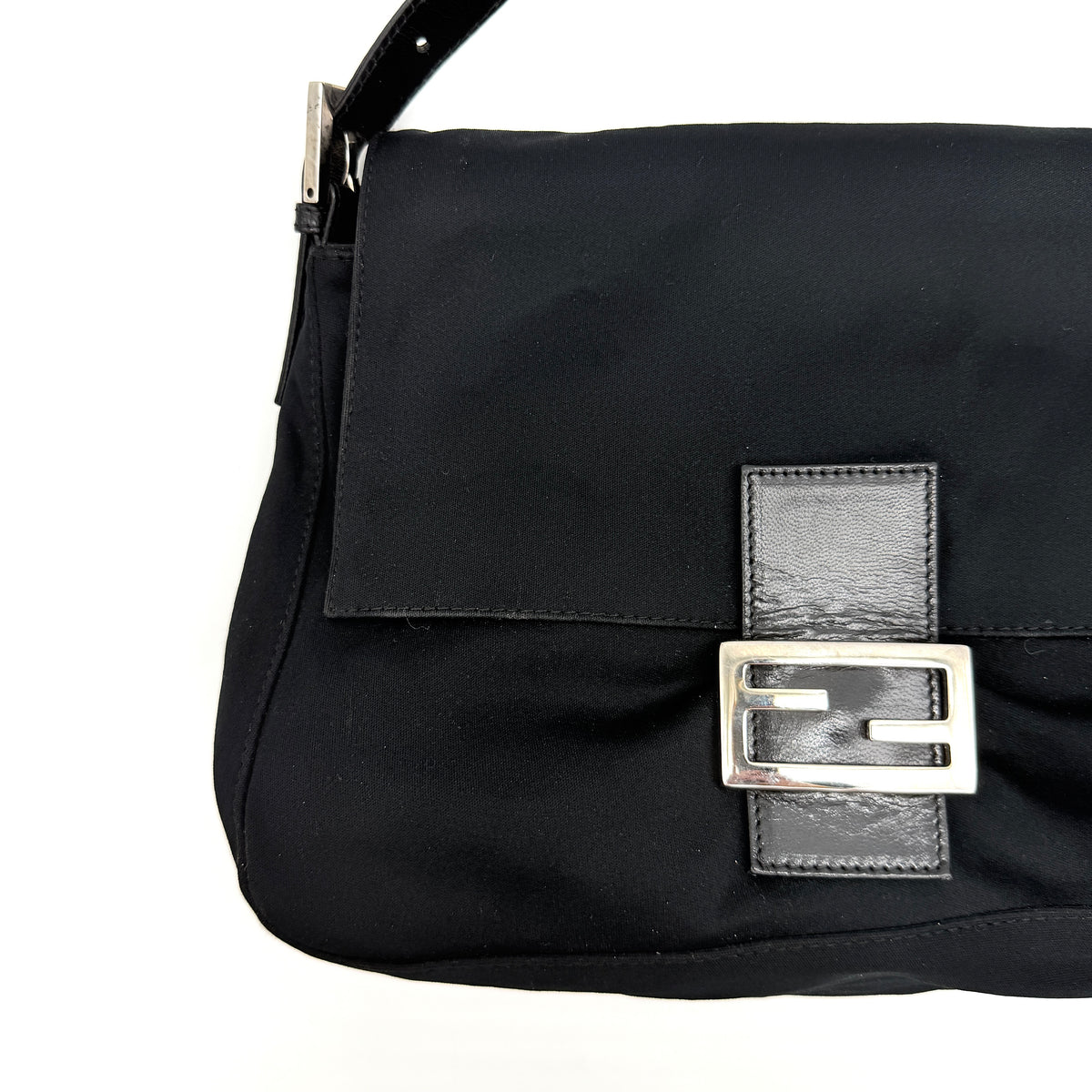 Fendi Mamma Baguette Shoulder Bag in black fabric with silver FF buckle and leather strap, photographed on a white backdrop.