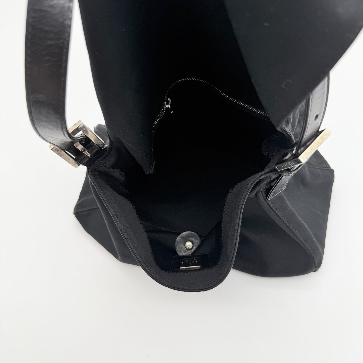 Fendi Mamma Baguette Shoulder Bag in black fabric with silver FF buckle and leather strap, photographed on a white backdrop.