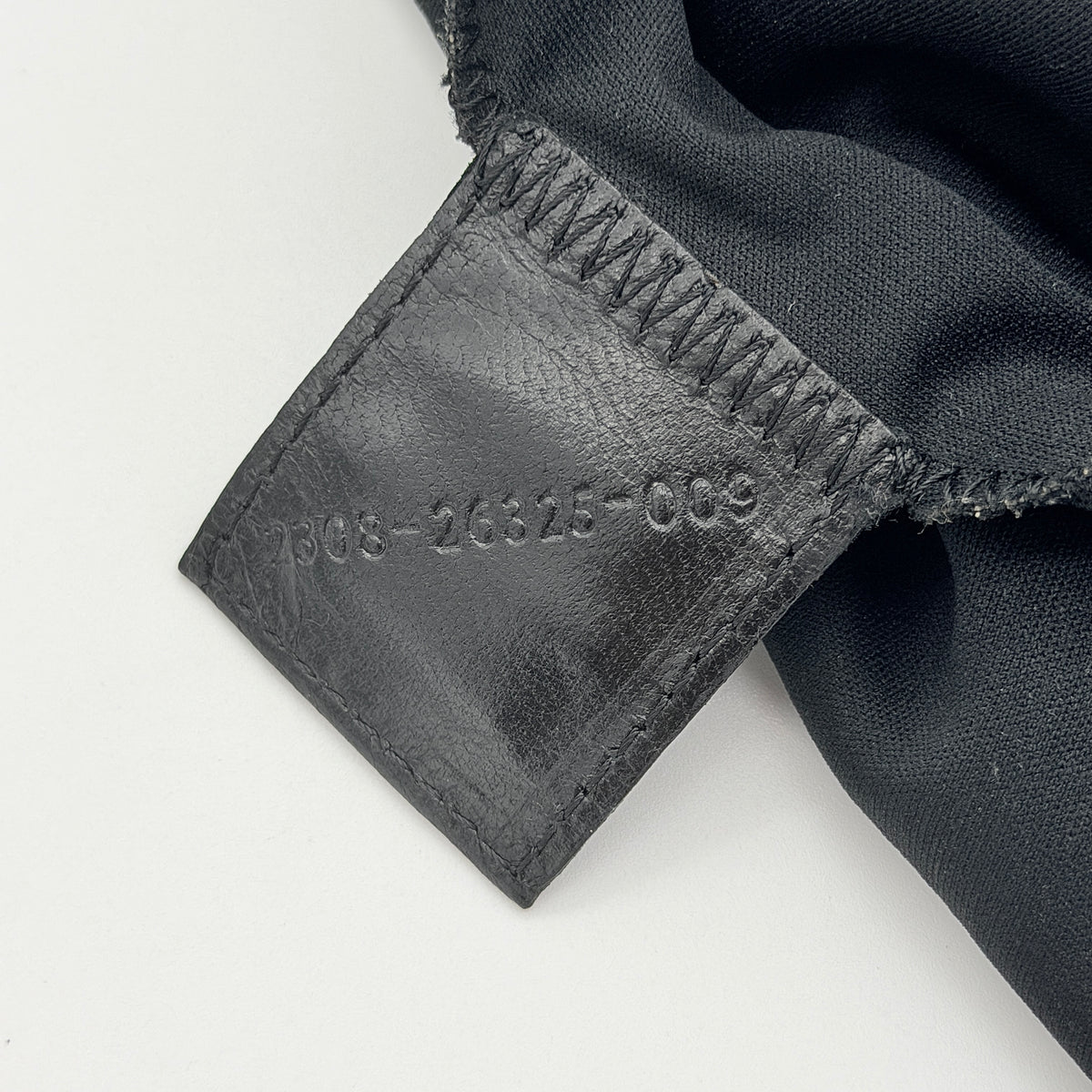 Fendi Mamma Baguette Shoulder Bag in black fabric with silver FF buckle and leather strap, photographed on a white backdrop.