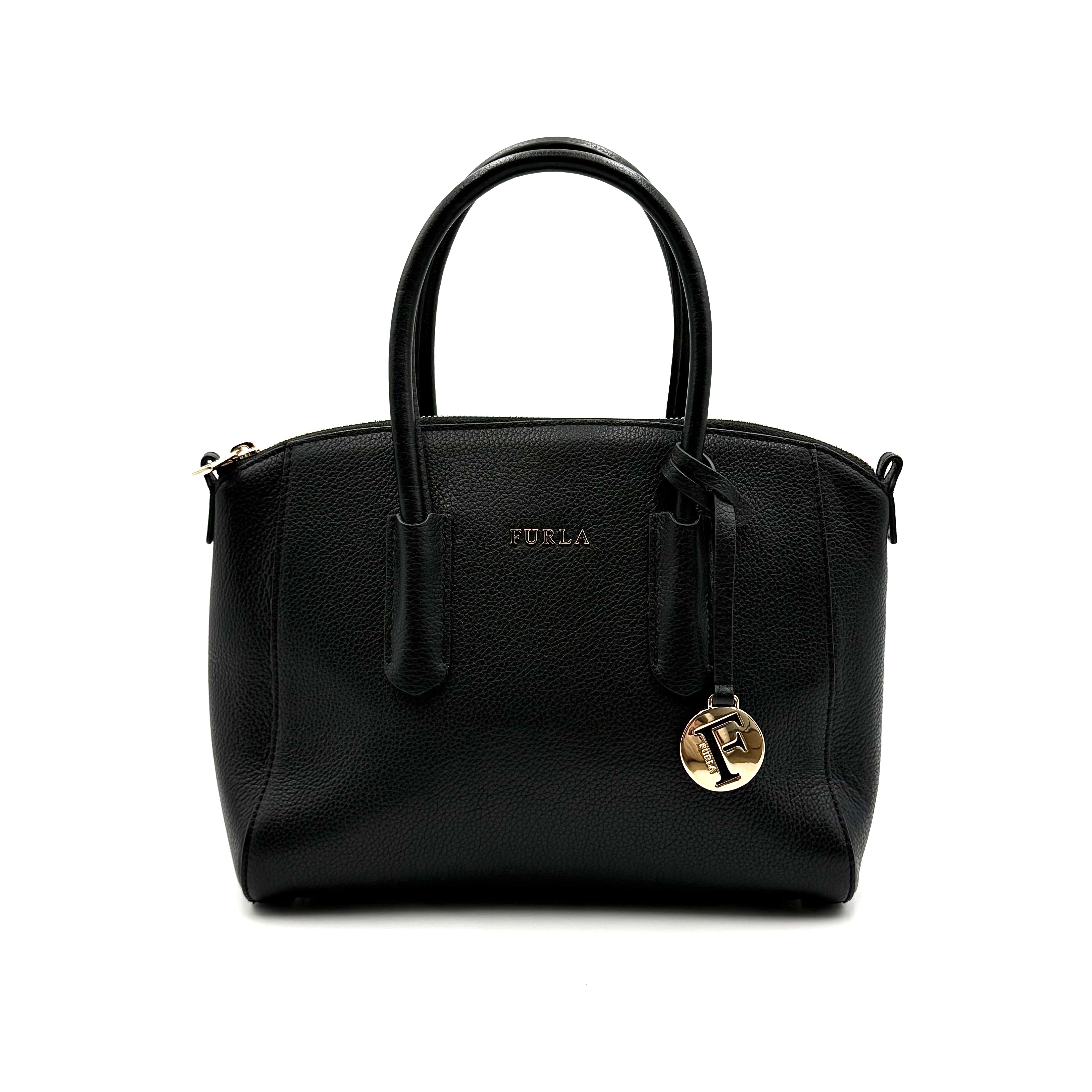 Front view of the Furla Tessa black leather satchel with gold-tone Furla charm and structured silhouette.