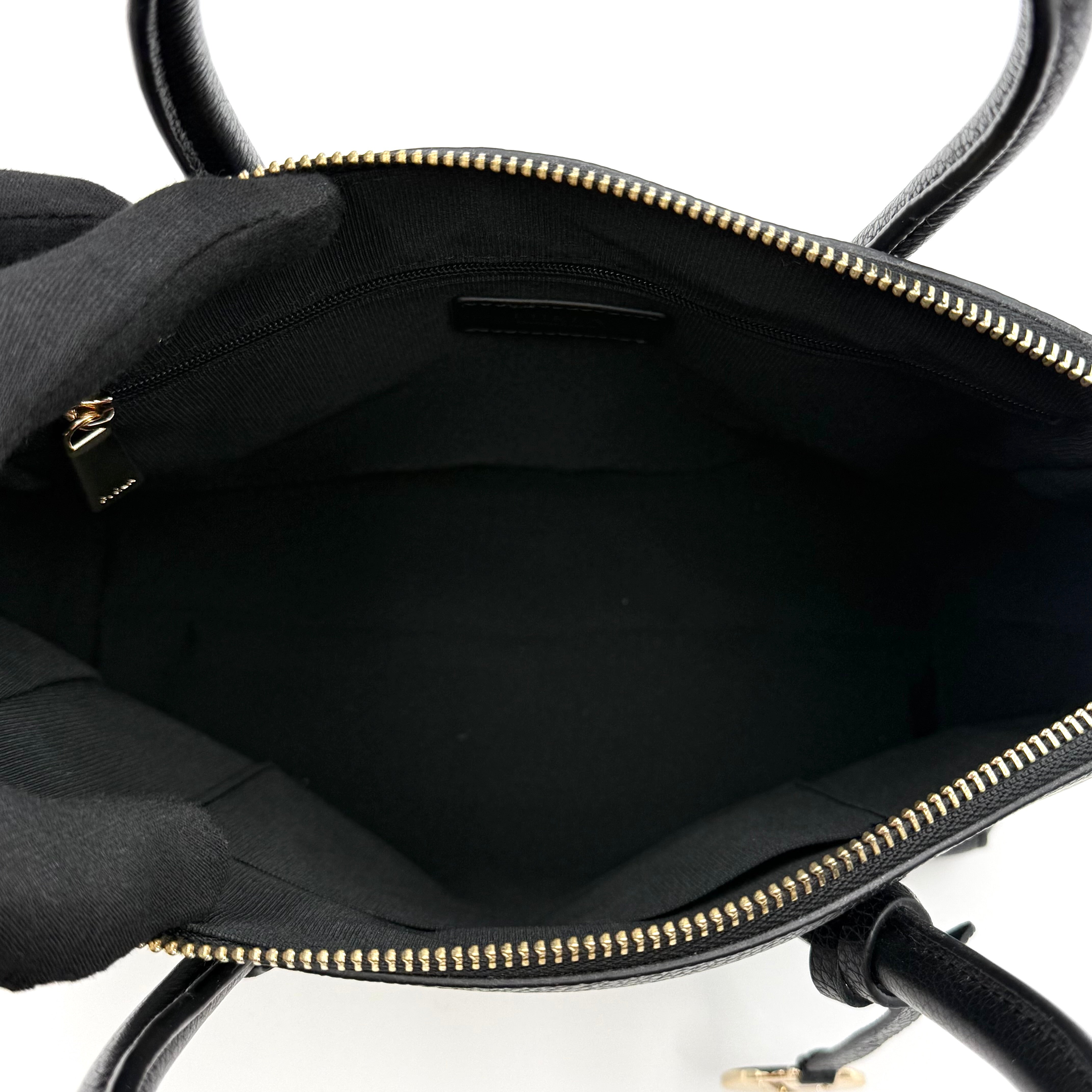 Front view of the Furla Tessa black leather satchel with gold-tone Furla charm and structured silhouette.