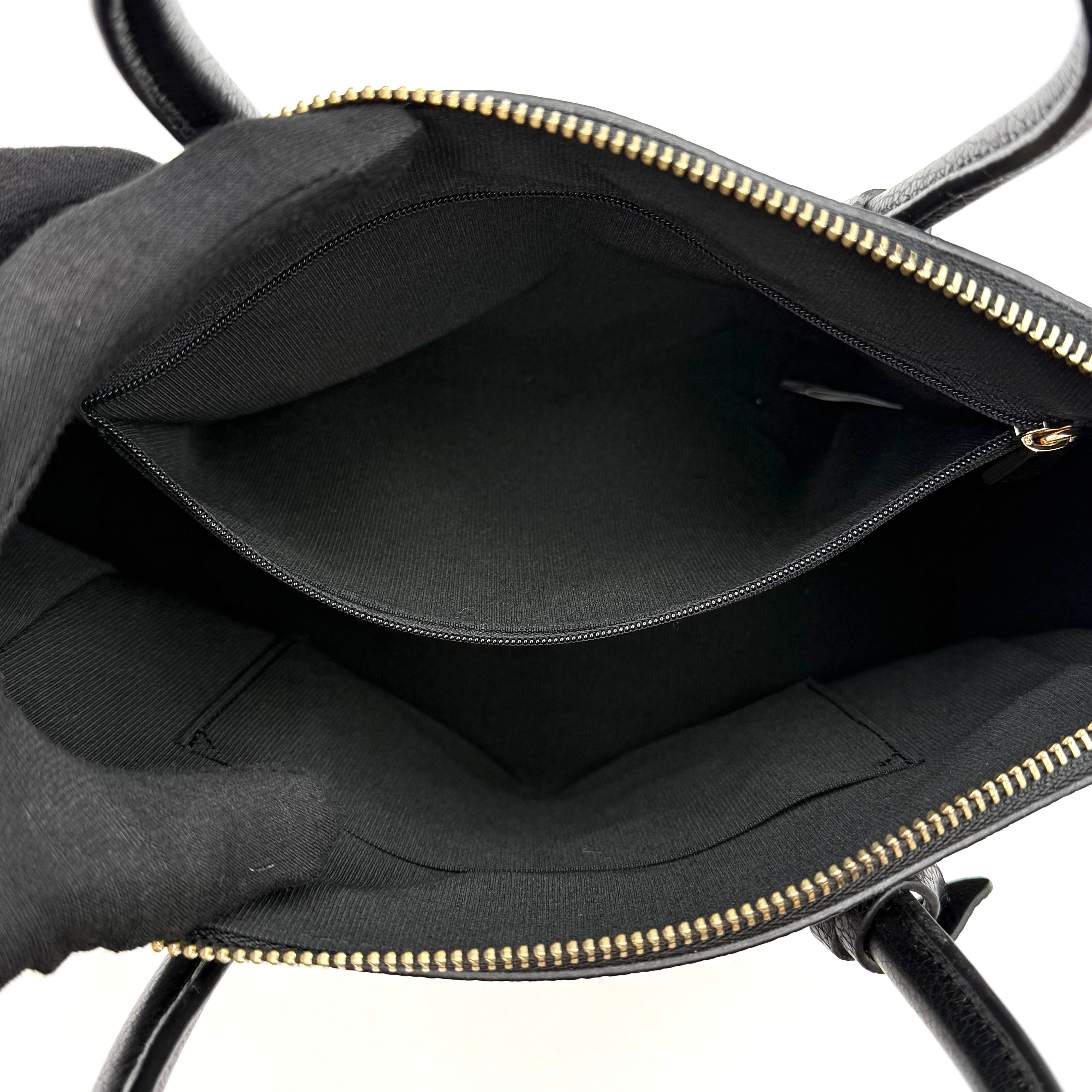 Front view of the Furla Tessa black leather satchel with gold-tone Furla charm and structured silhouette.