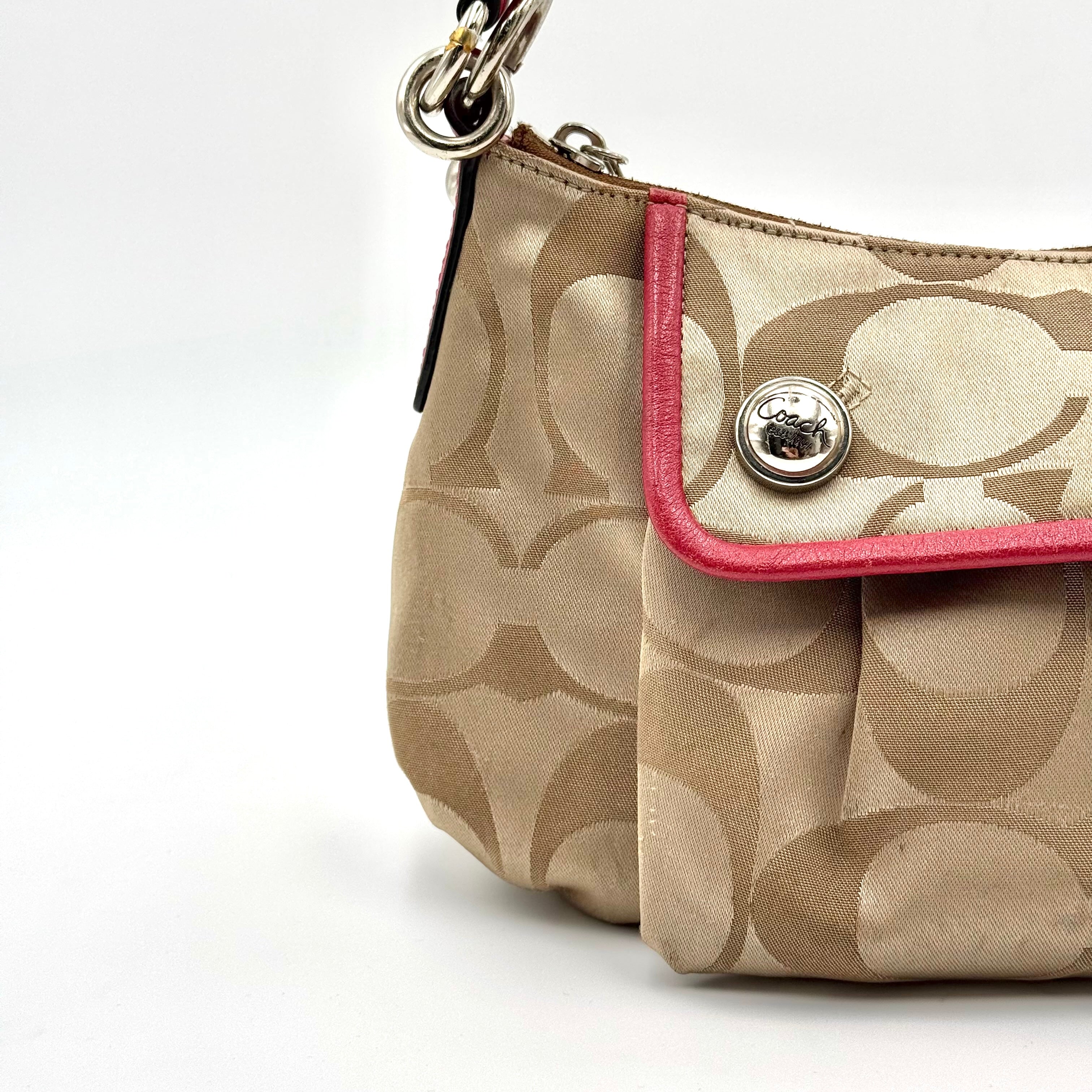Coach Signature Poppy Sateen Groovy Shoulder Bag in beige with pink trim and detachable strap, displayed on a white background.