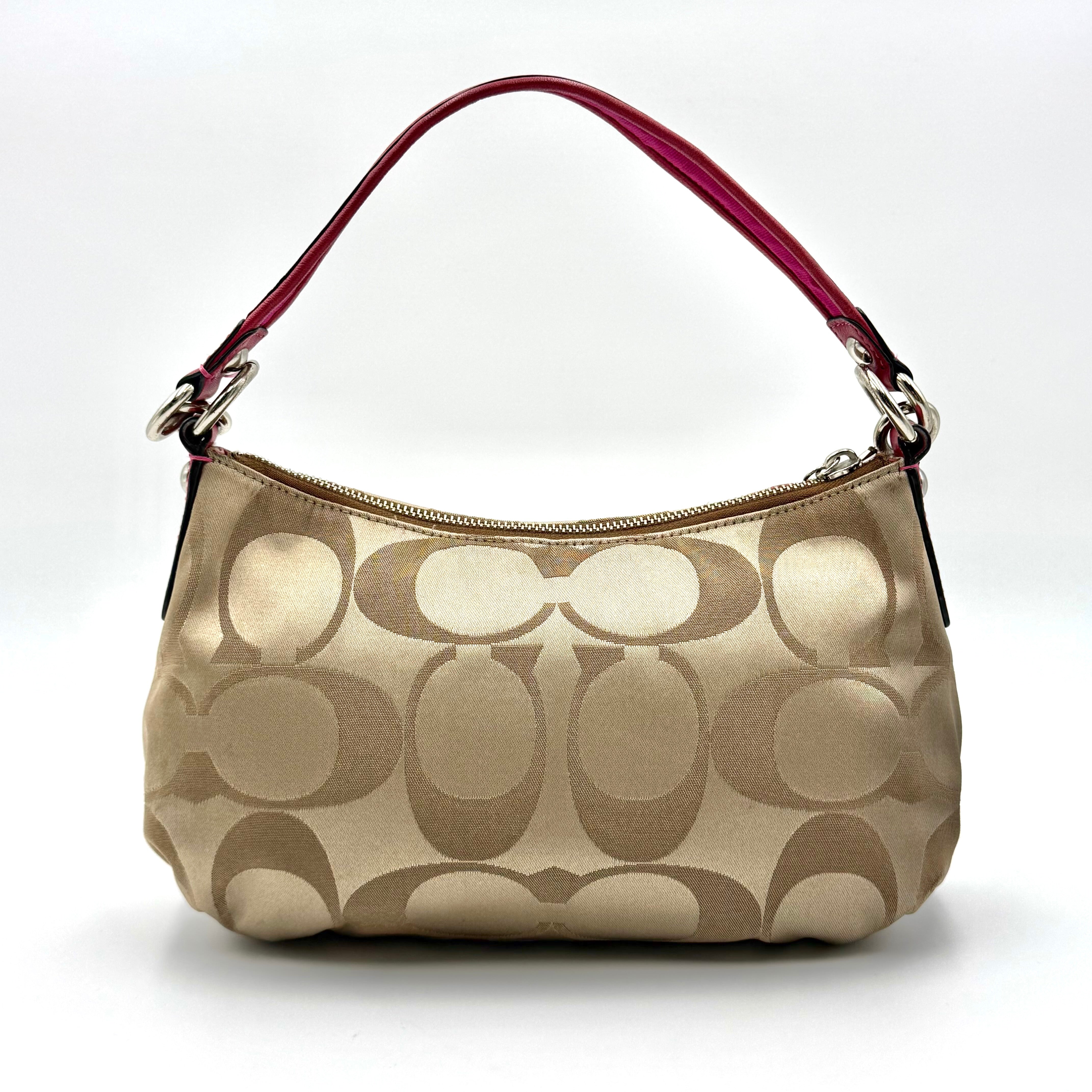 Coach Signature Poppy Sateen Groovy Shoulder Bag in beige with pink trim and detachable strap, displayed on a white background.