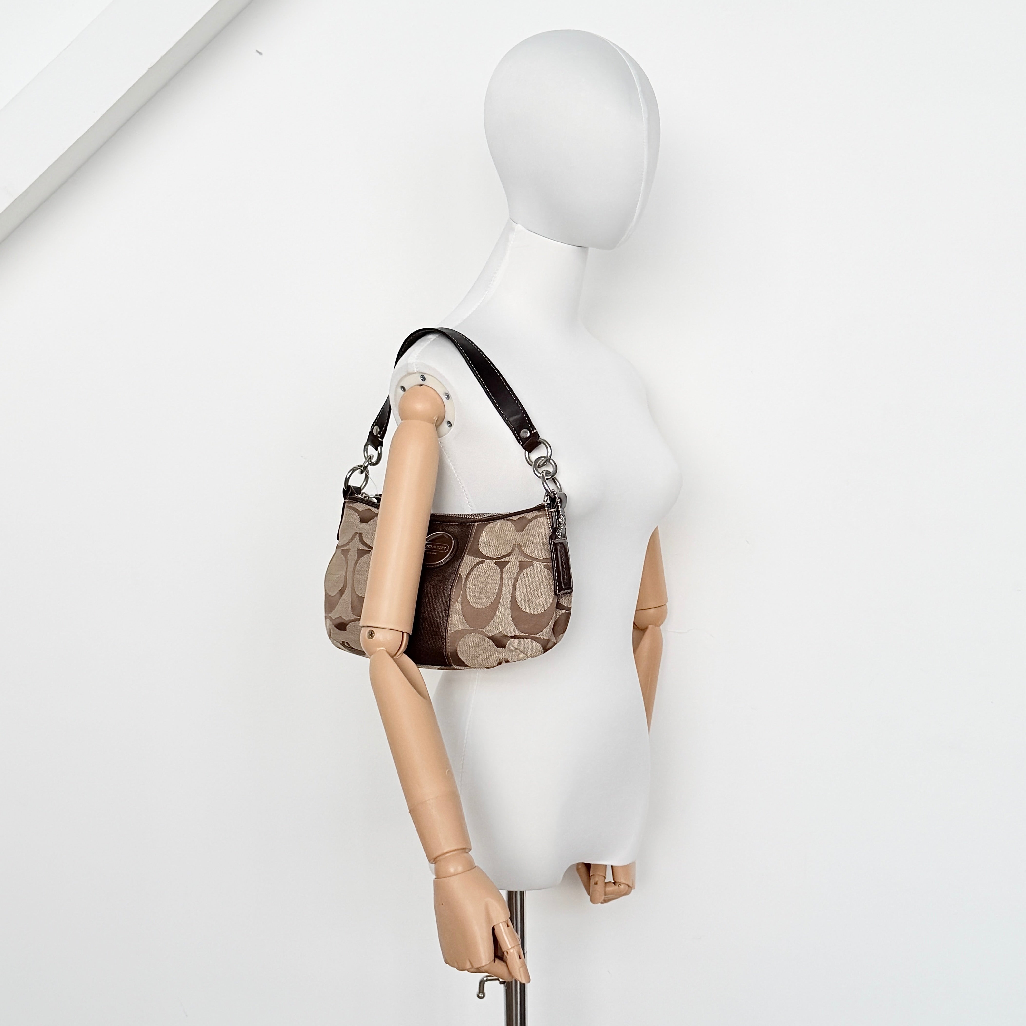 Coach khaki and mahogany signature jacquard shoulder bag with detachable strap and silver hardware displayed on a white background.