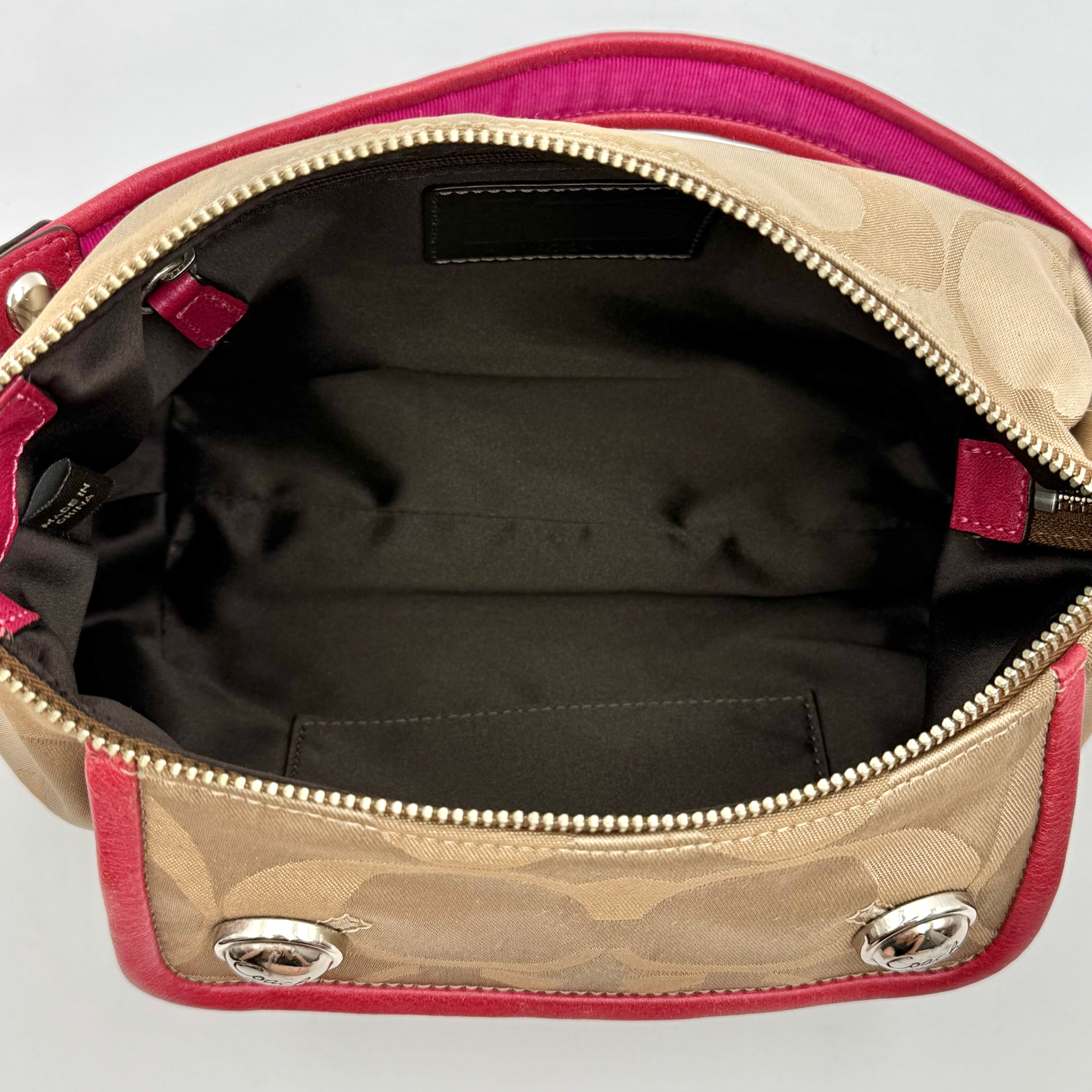 Coach Signature Poppy Sateen Groovy Shoulder Bag in beige with pink trim and detachable strap, displayed on a white background.