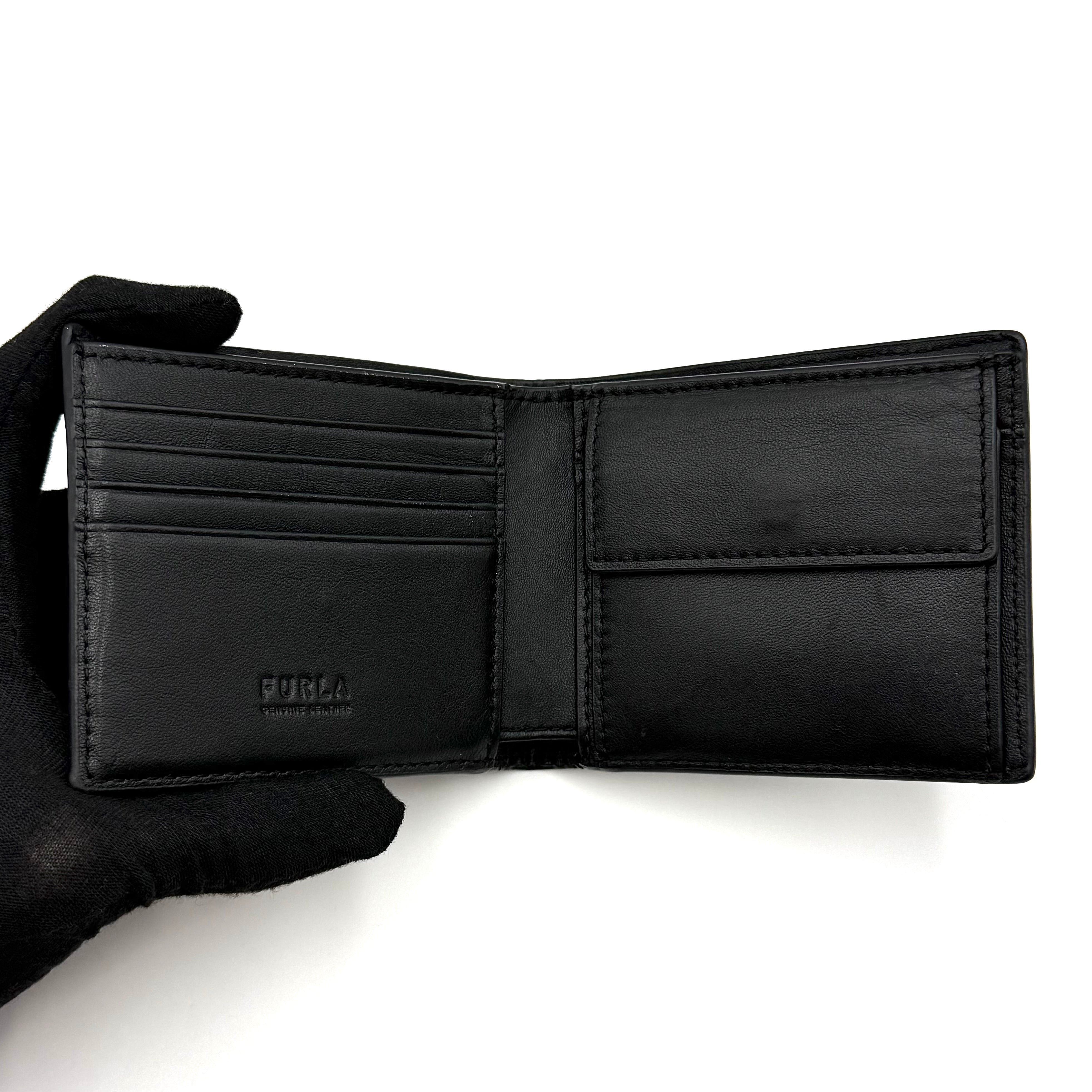 Furla Man Cosmo black leather bifold wallet with a textured teddy bear patch on the front.