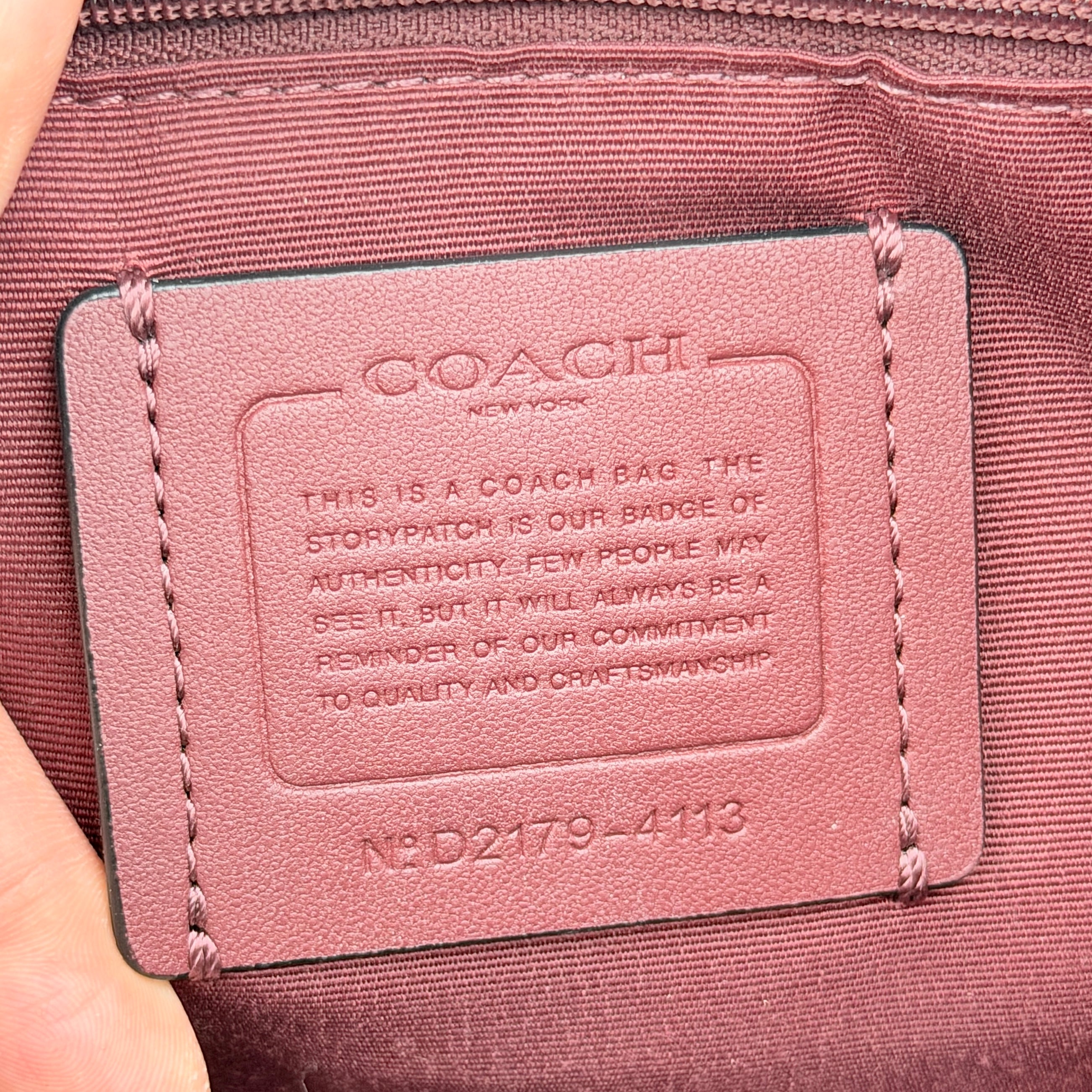 Coach 2Way Signature 22 Dempsey Tote in brown jacquard and burgundy leather with orange logo patch, shown with detachable strap.