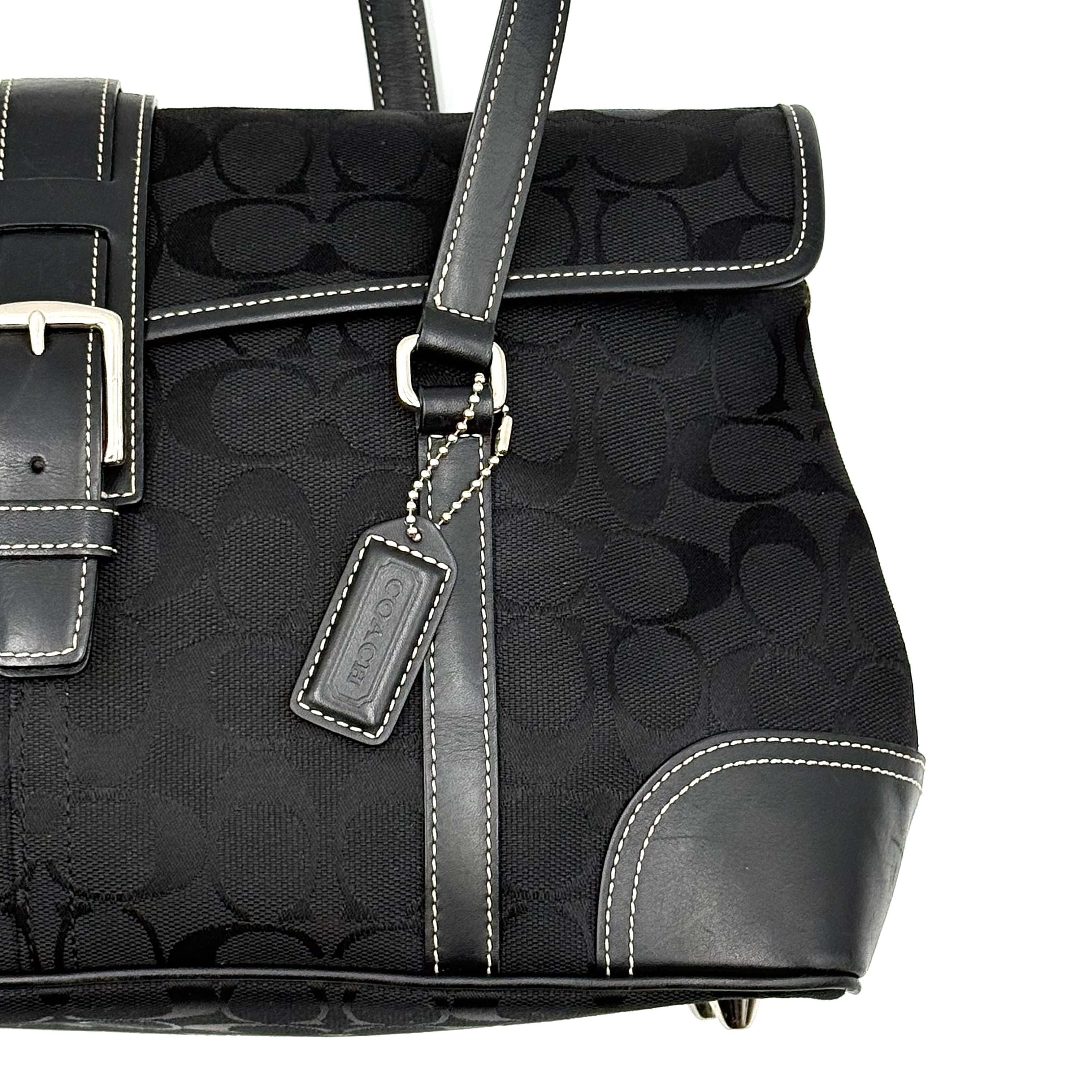 Coach black Soho Hampton Buckle Flap Shoulder Bag with jacquard pattern, leather trim, and silver buckle detail.