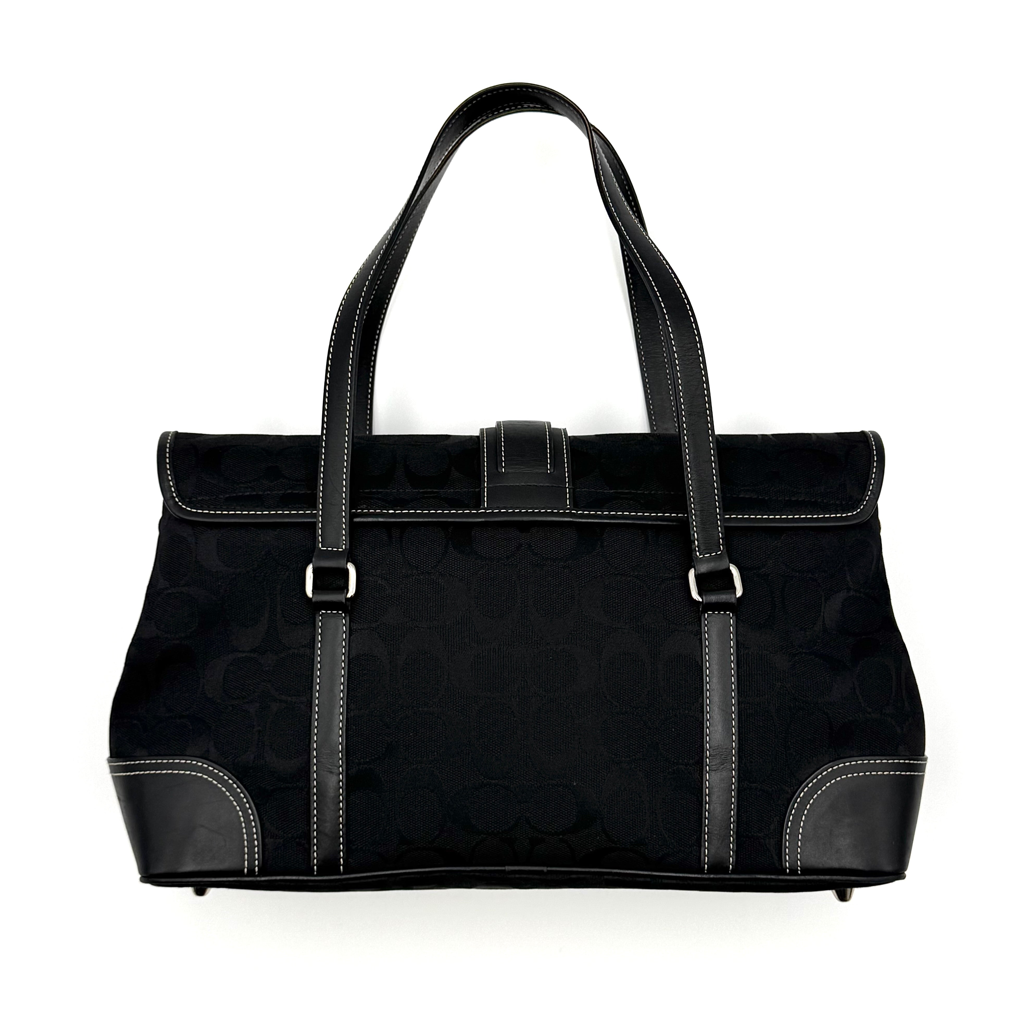 Coach black Soho Hampton Buckle Flap Shoulder Bag with jacquard pattern, leather trim, and silver buckle detail.