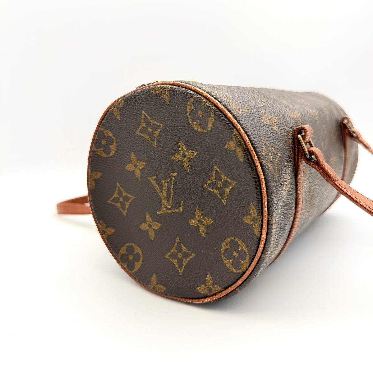 Louis Vuitton Papillon 26 in monogram canvas with leather handles and gold zipper, shown on a white background.