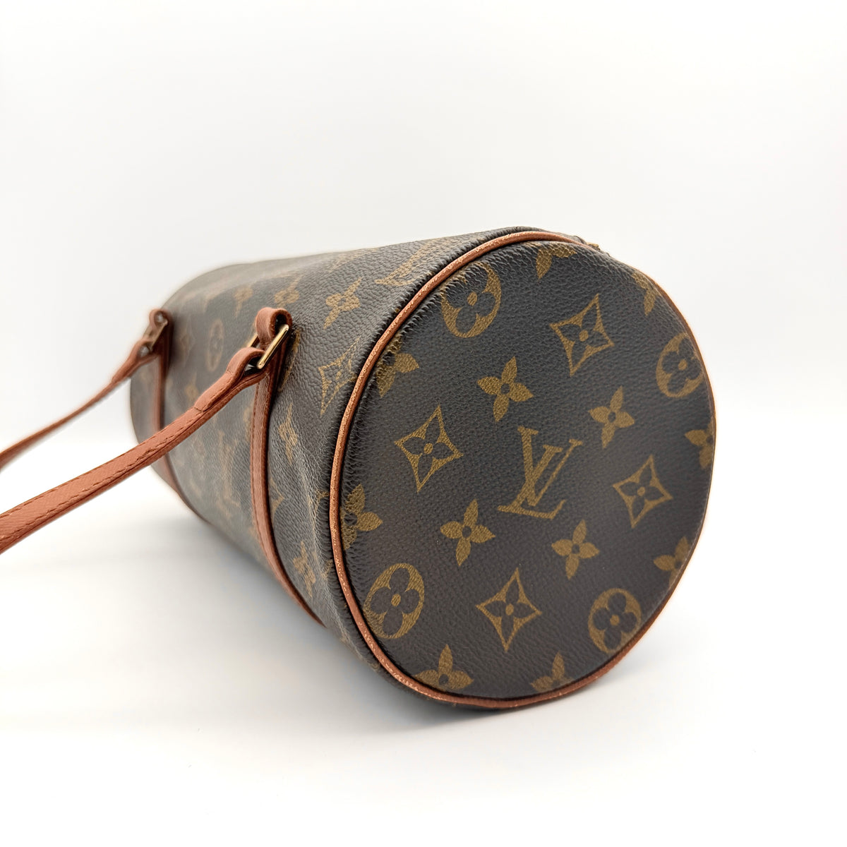 Louis Vuitton Papillon 26 in monogram canvas with leather handles and gold zipper, shown on a white background.