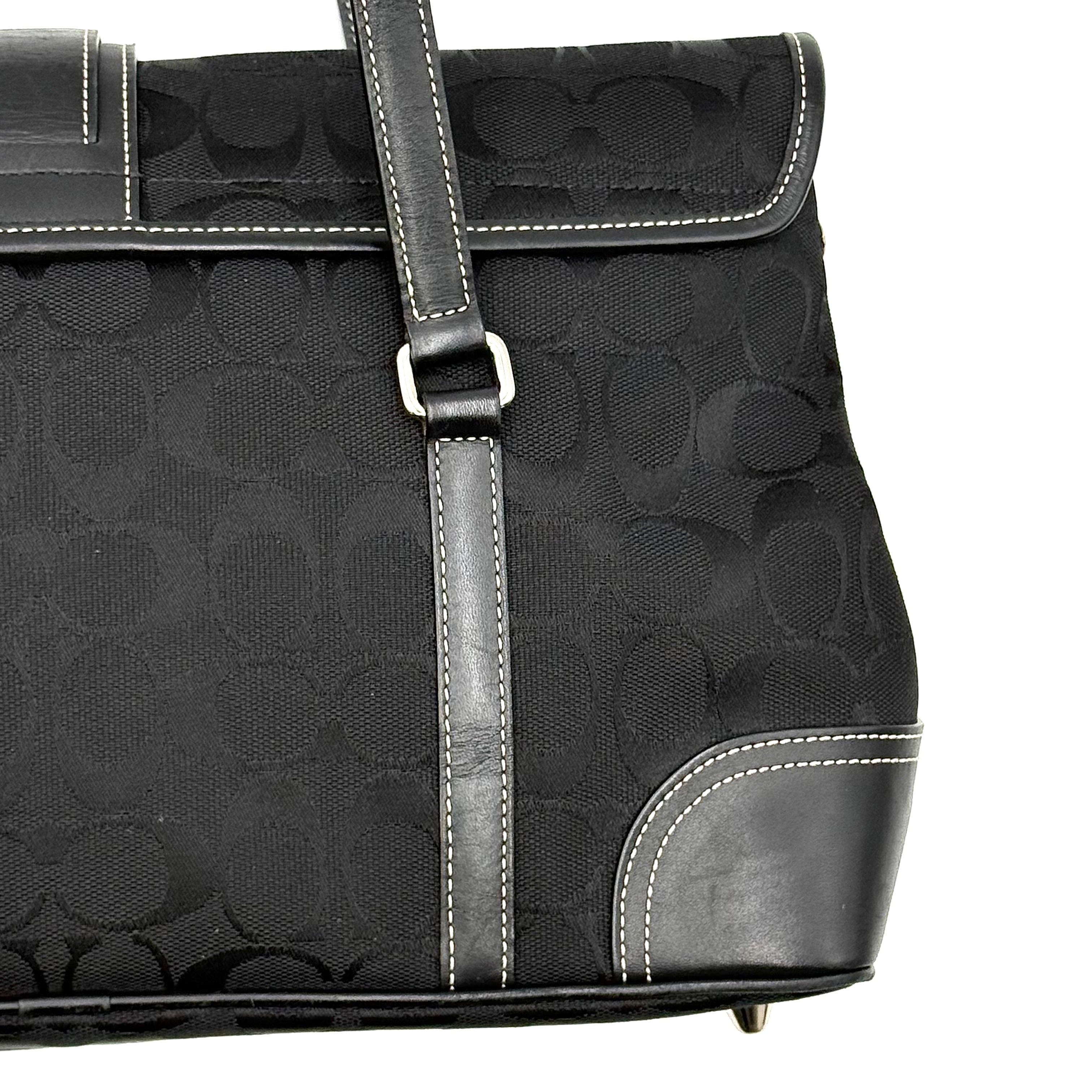 Coach black Soho Hampton Buckle Flap Shoulder Bag with jacquard pattern, leather trim, and silver buckle detail.