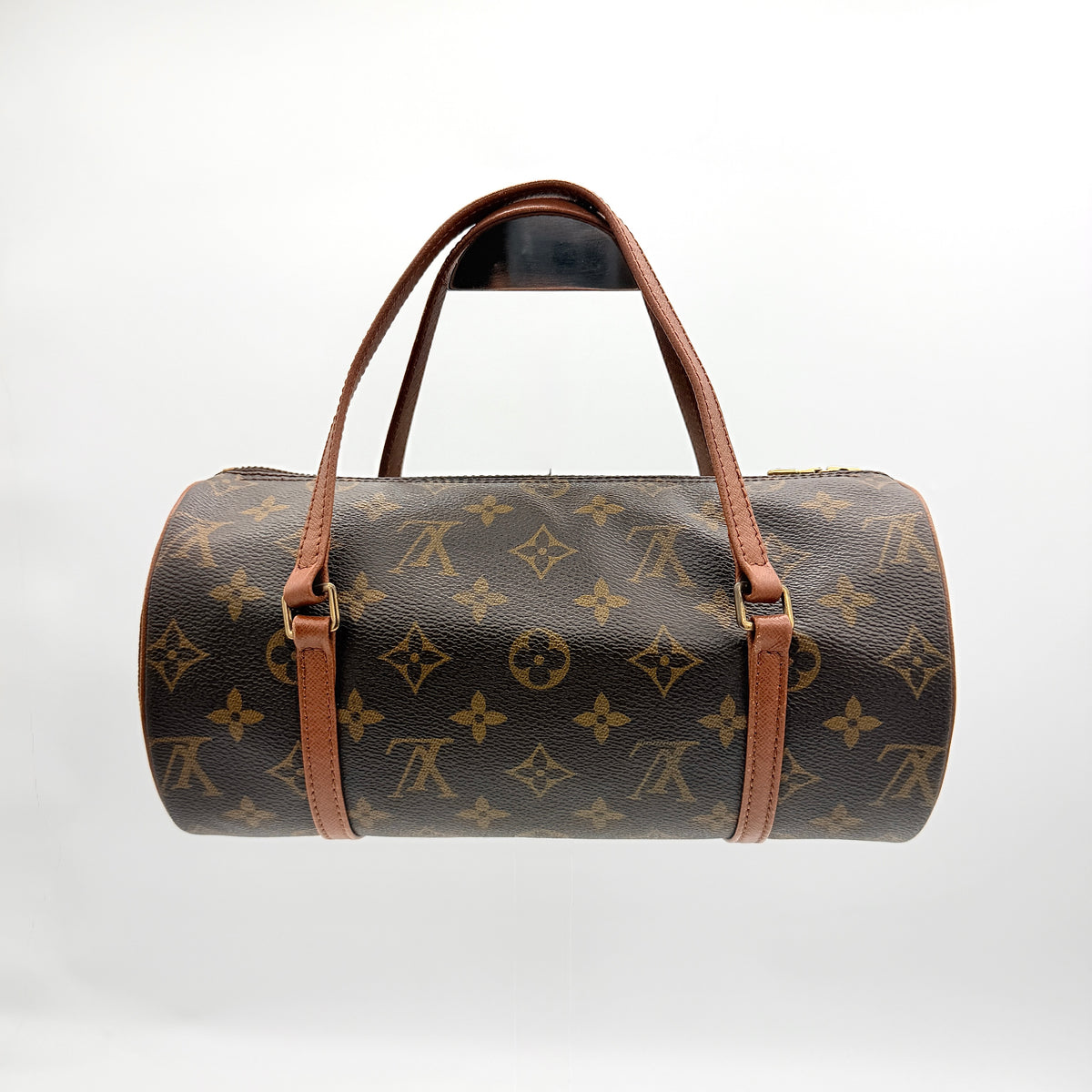 Louis Vuitton Papillon 26 in monogram canvas with leather handles and gold zipper, shown on a white background.