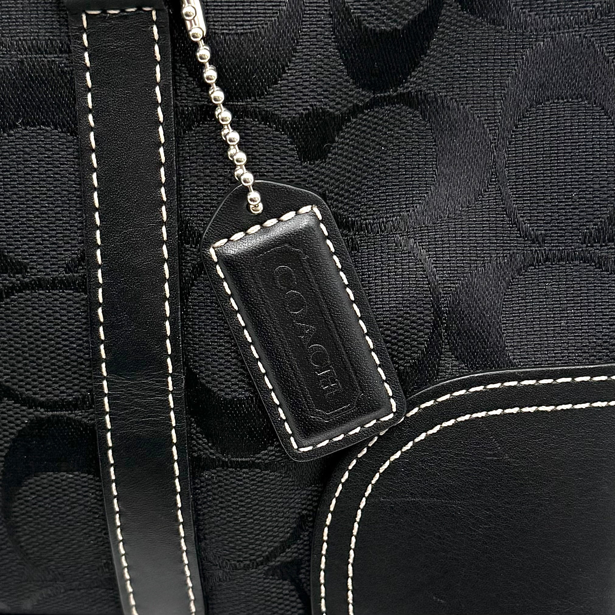 Coach black Soho Hampton Buckle Flap Shoulder Bag with jacquard pattern, leather trim, and silver buckle detail.