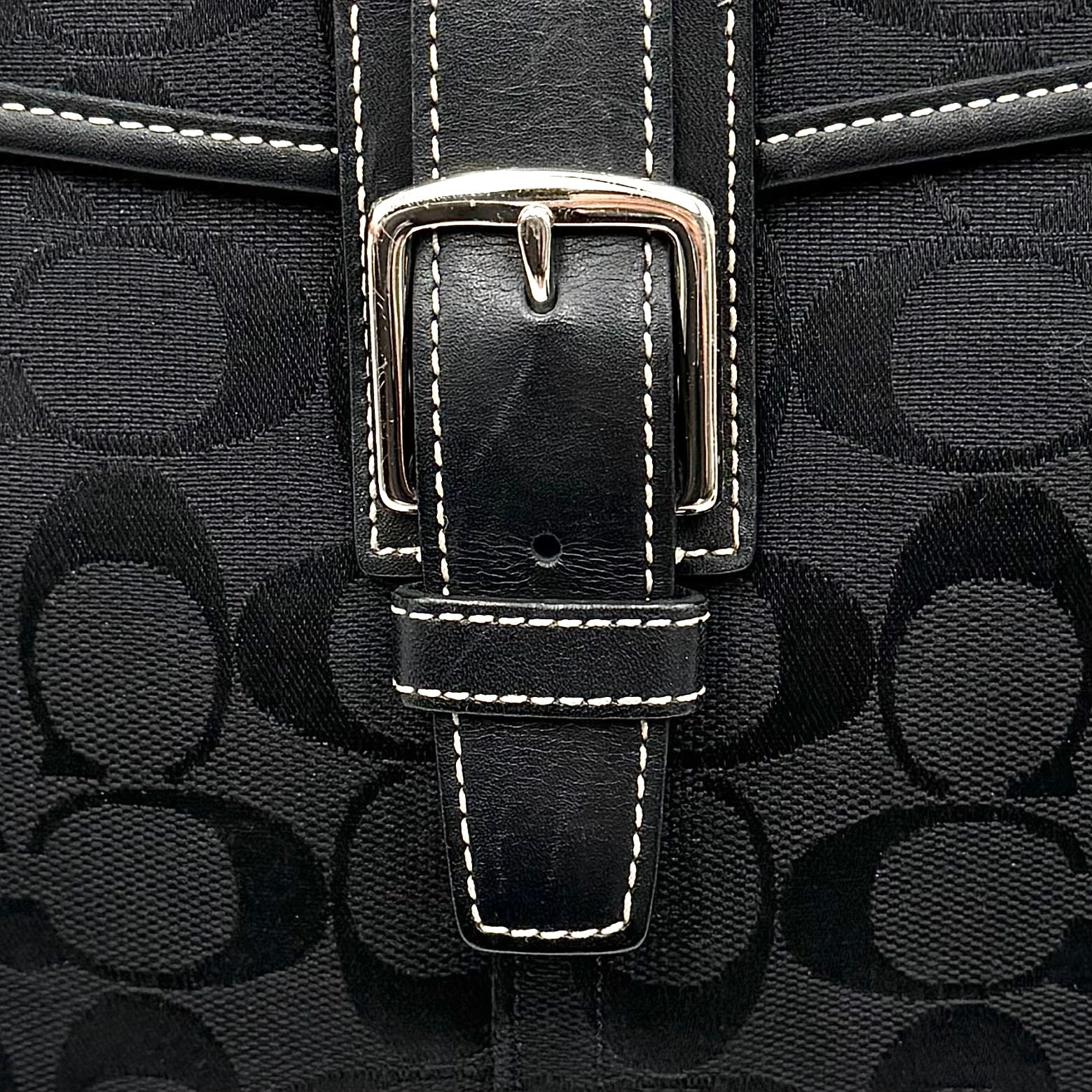 Coach black Soho Hampton Buckle Flap Shoulder Bag with jacquard pattern, leather trim, and silver buckle detail.