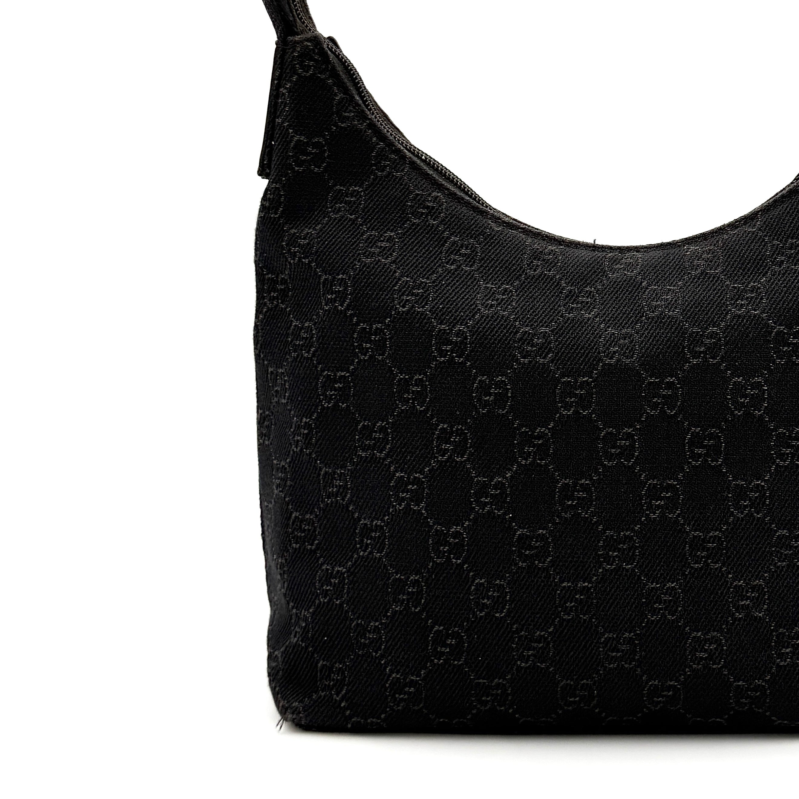 A brown Gucci GG Monogram Hobo Shoulder Bag with a single shoulder strap, styled on a matching GG dust bag.