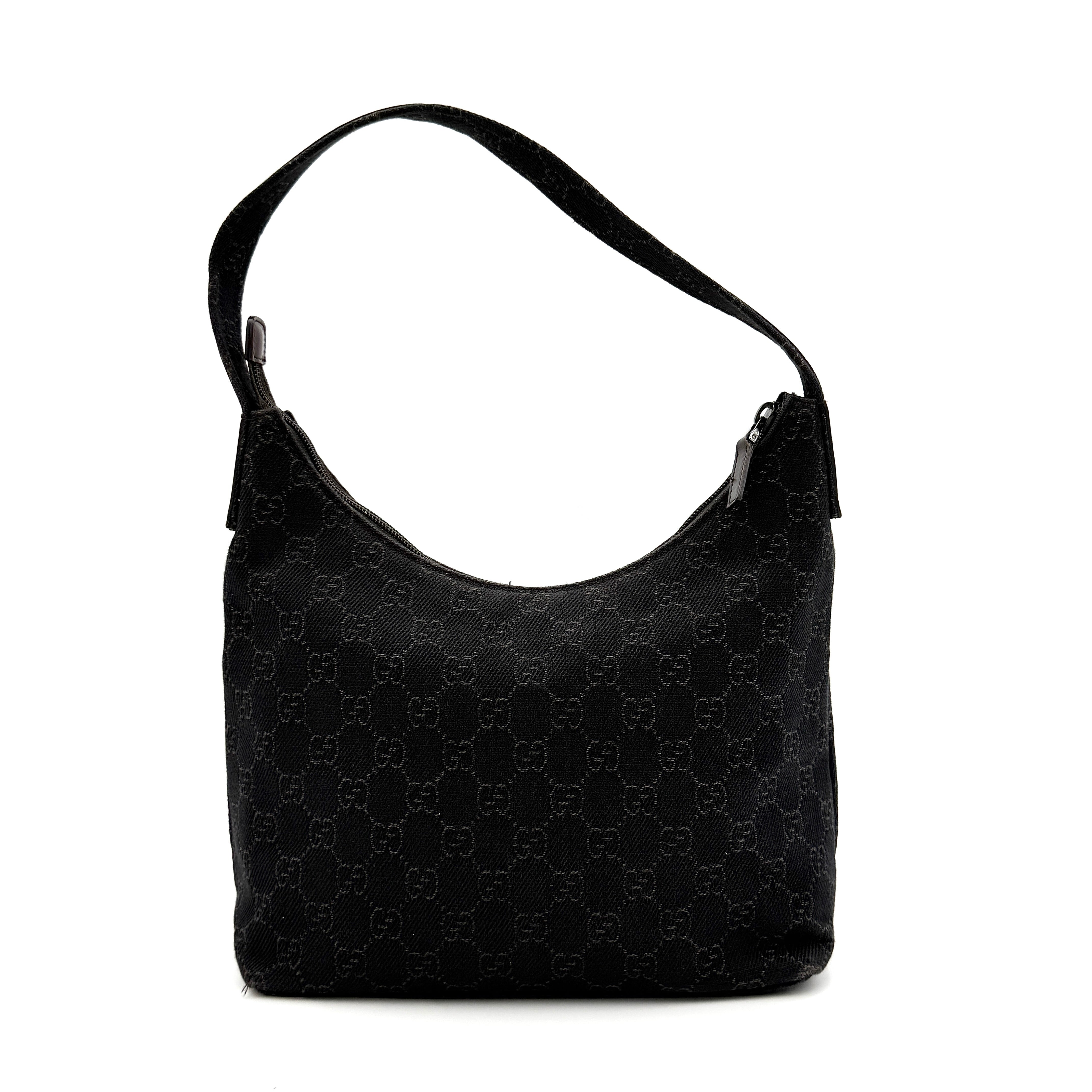 A brown Gucci GG Monogram Hobo Shoulder Bag with a single shoulder strap, styled on a matching GG dust bag.