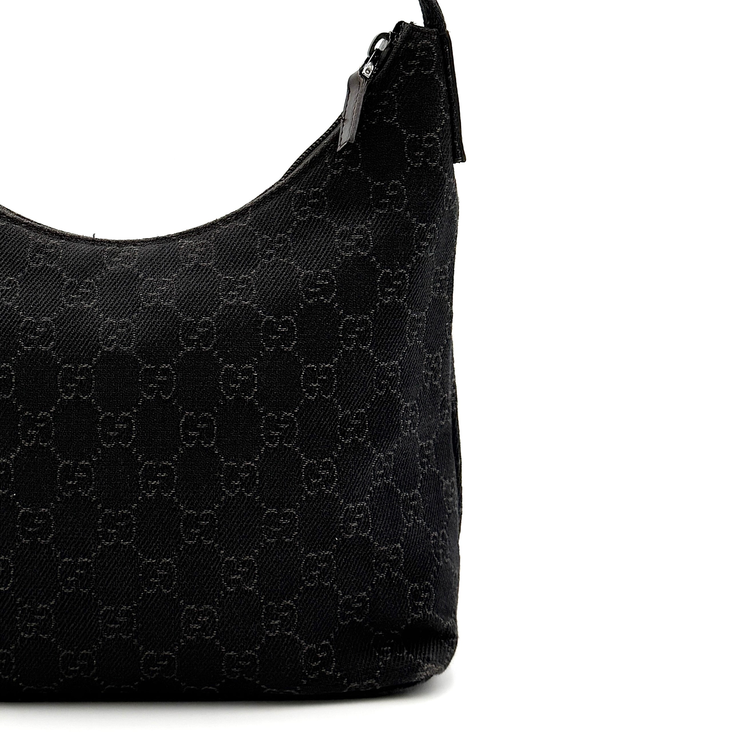A brown Gucci GG Monogram Hobo Shoulder Bag with a single shoulder strap, styled on a matching GG dust bag.
