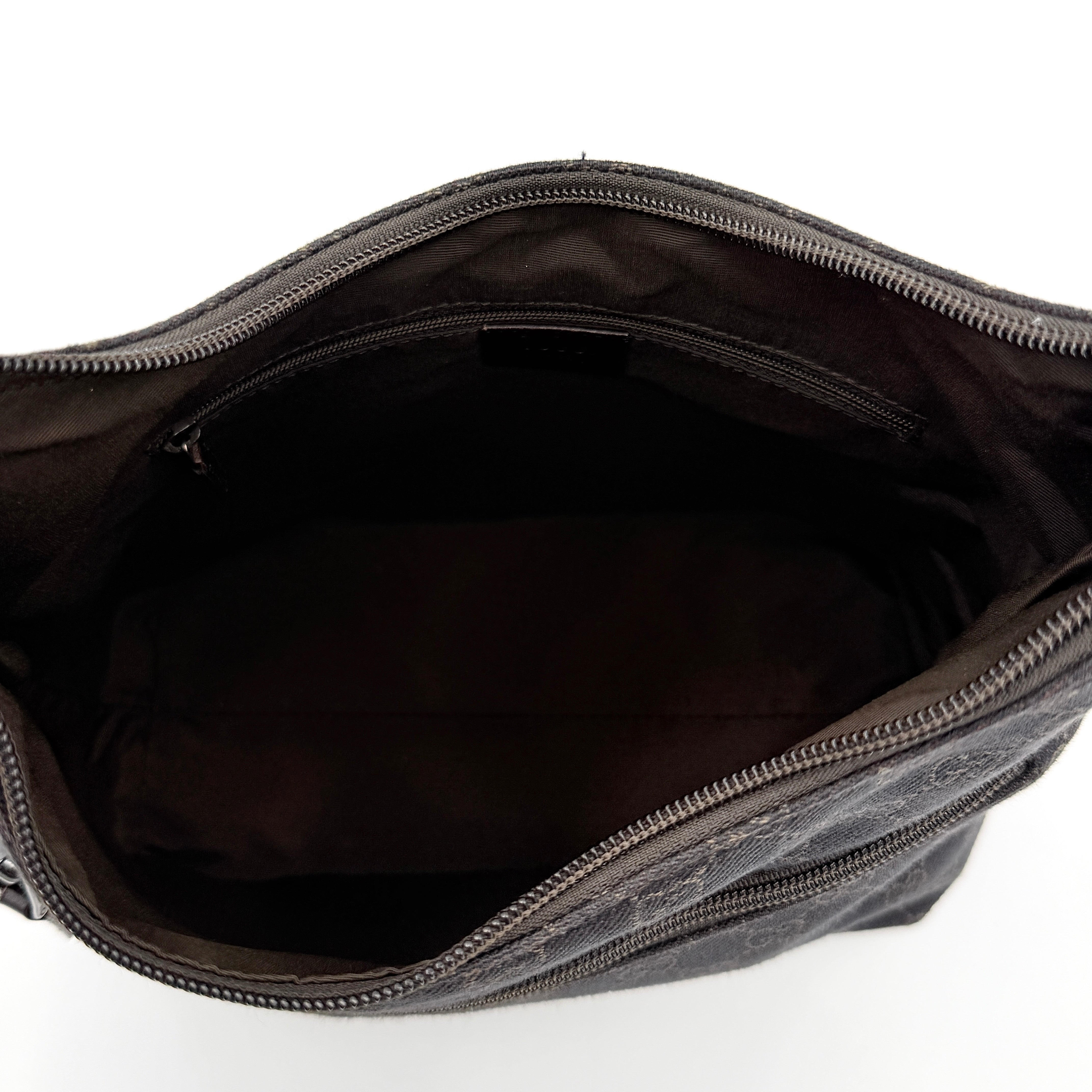A brown Gucci GG Monogram Hobo Shoulder Bag with a single shoulder strap, styled on a matching GG dust bag.