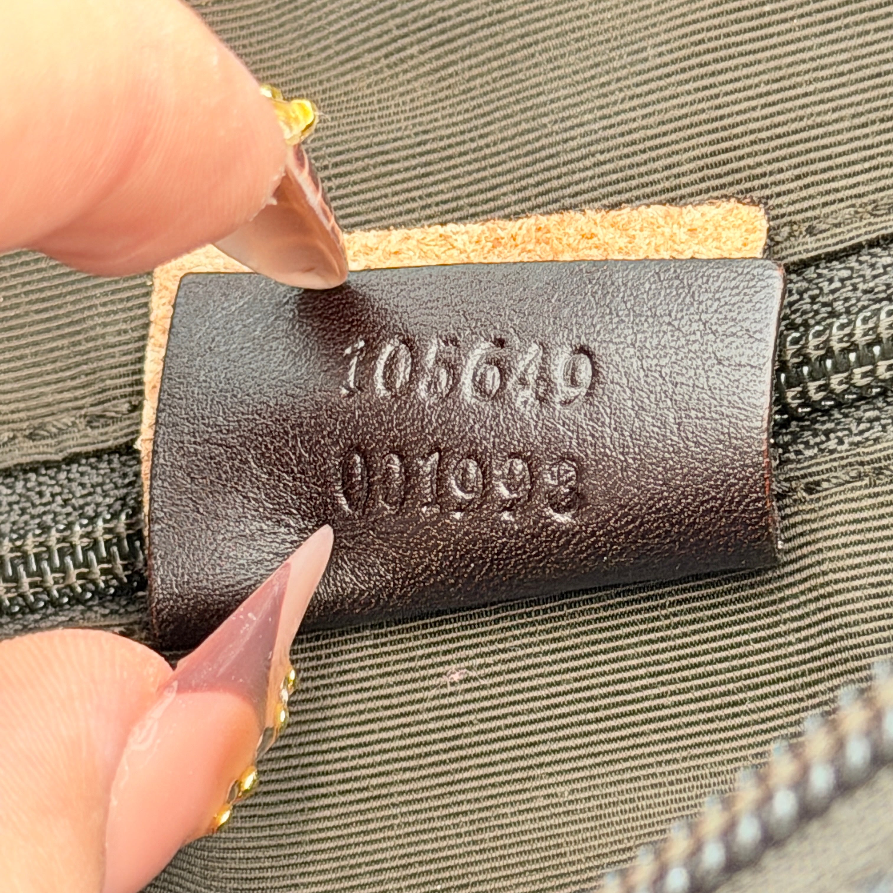 A brown Gucci GG Monogram Hobo Shoulder Bag with a single shoulder strap, styled on a matching GG dust bag.