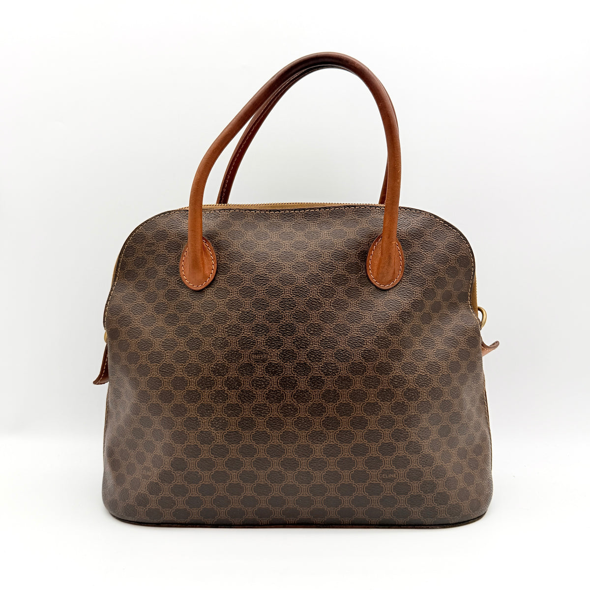 Celine Triomphe Macadam Dome Handbag in brown coated canvas with tan leather handles, shown against a white background.