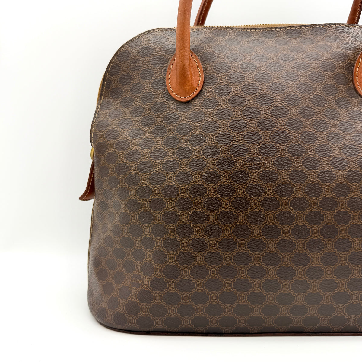 Celine Triomphe Macadam Dome Handbag in brown coated canvas with tan leather handles, shown against a white background.
