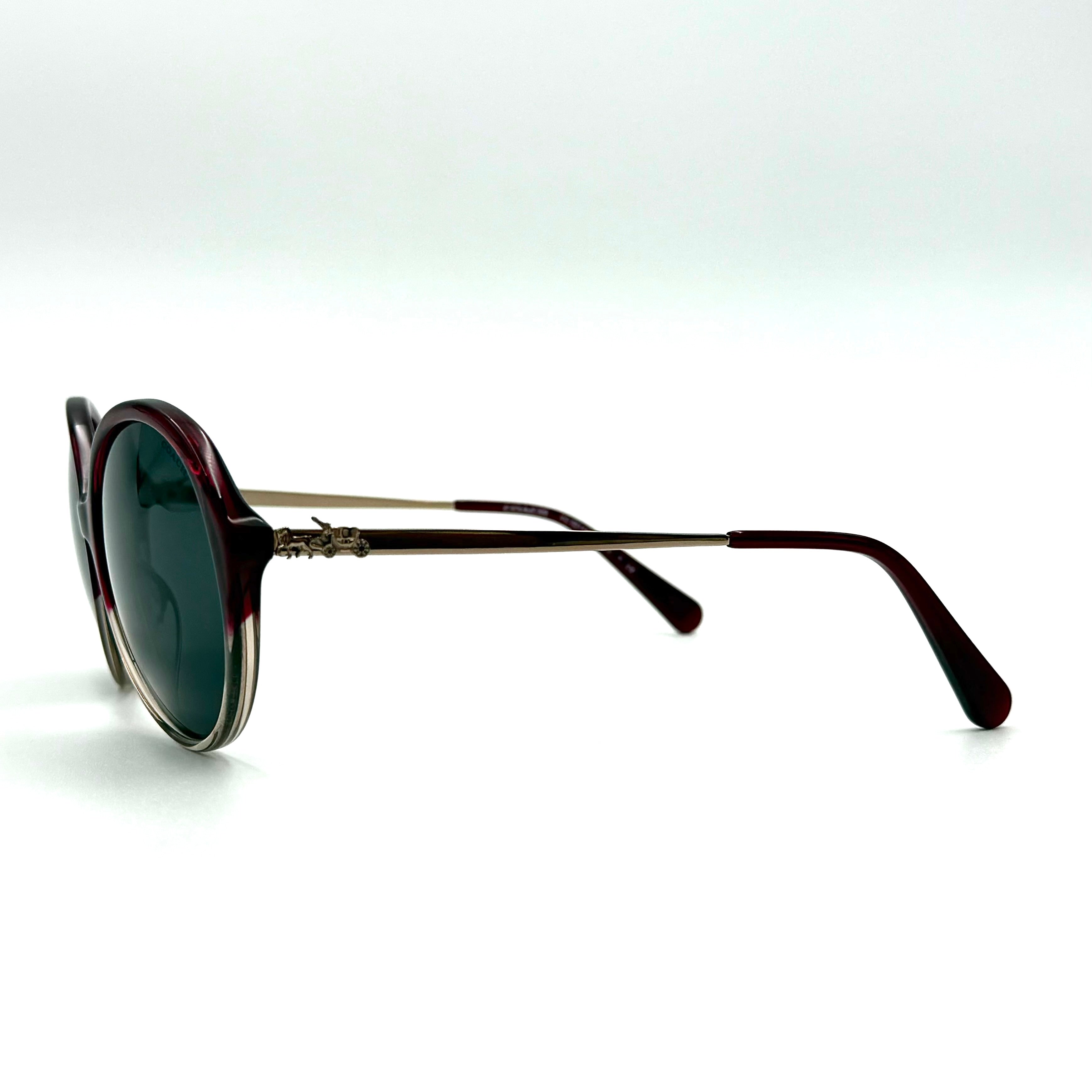 Coach HC8214F sunglasses in a red-to-sand gradient acetate frame with gold-tone metal temples and signature carriage detail.