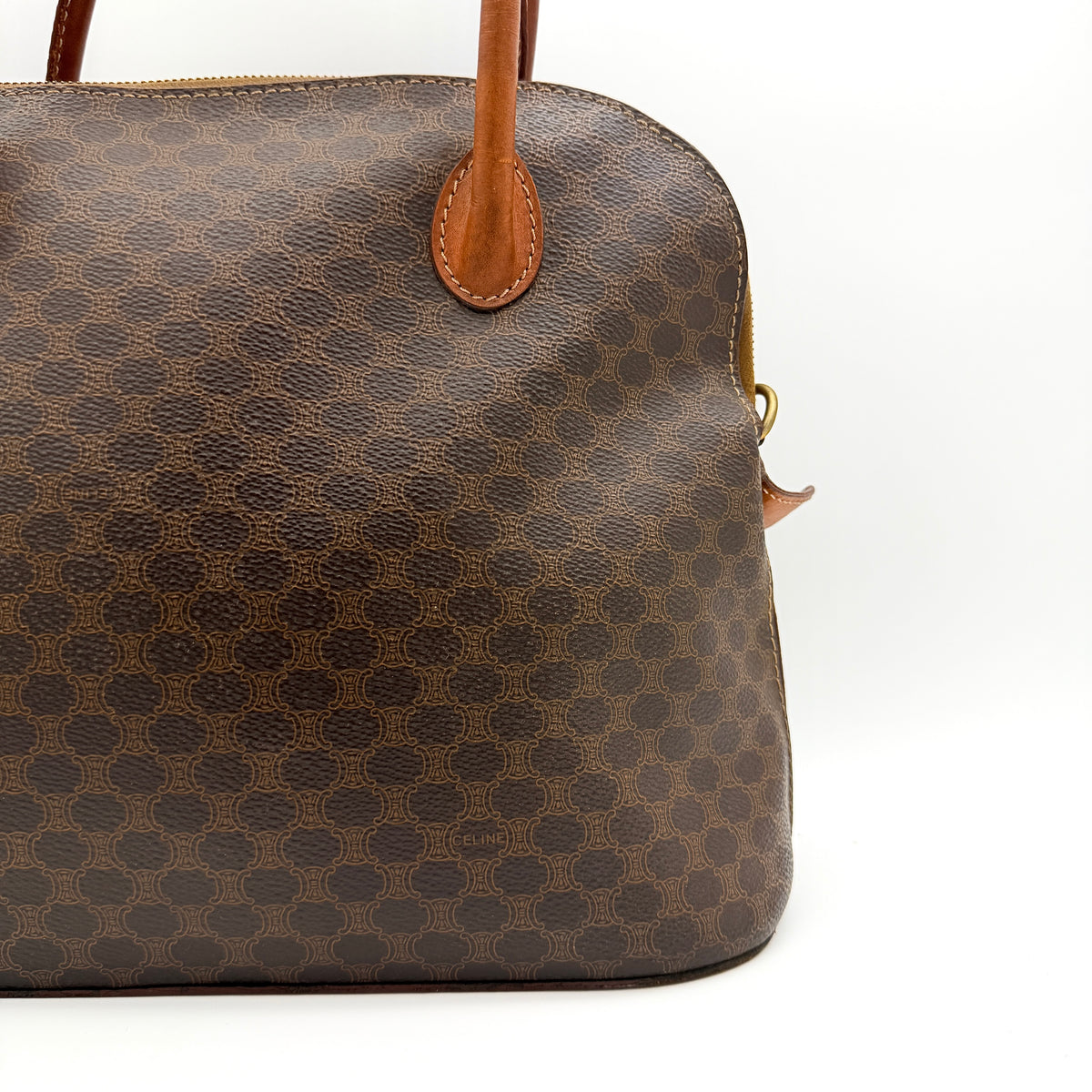 Celine Triomphe Macadam Dome Handbag in brown coated canvas with tan leather handles, shown against a white background.