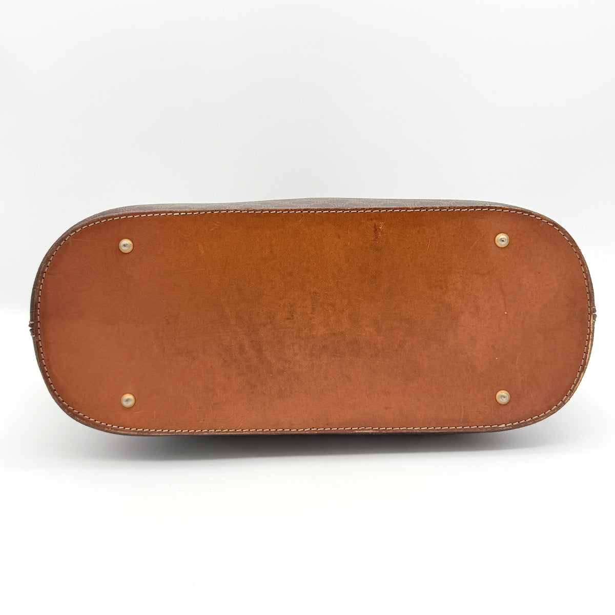 Celine Triomphe Macadam Dome Handbag in brown coated canvas with tan leather handles, shown against a white background.