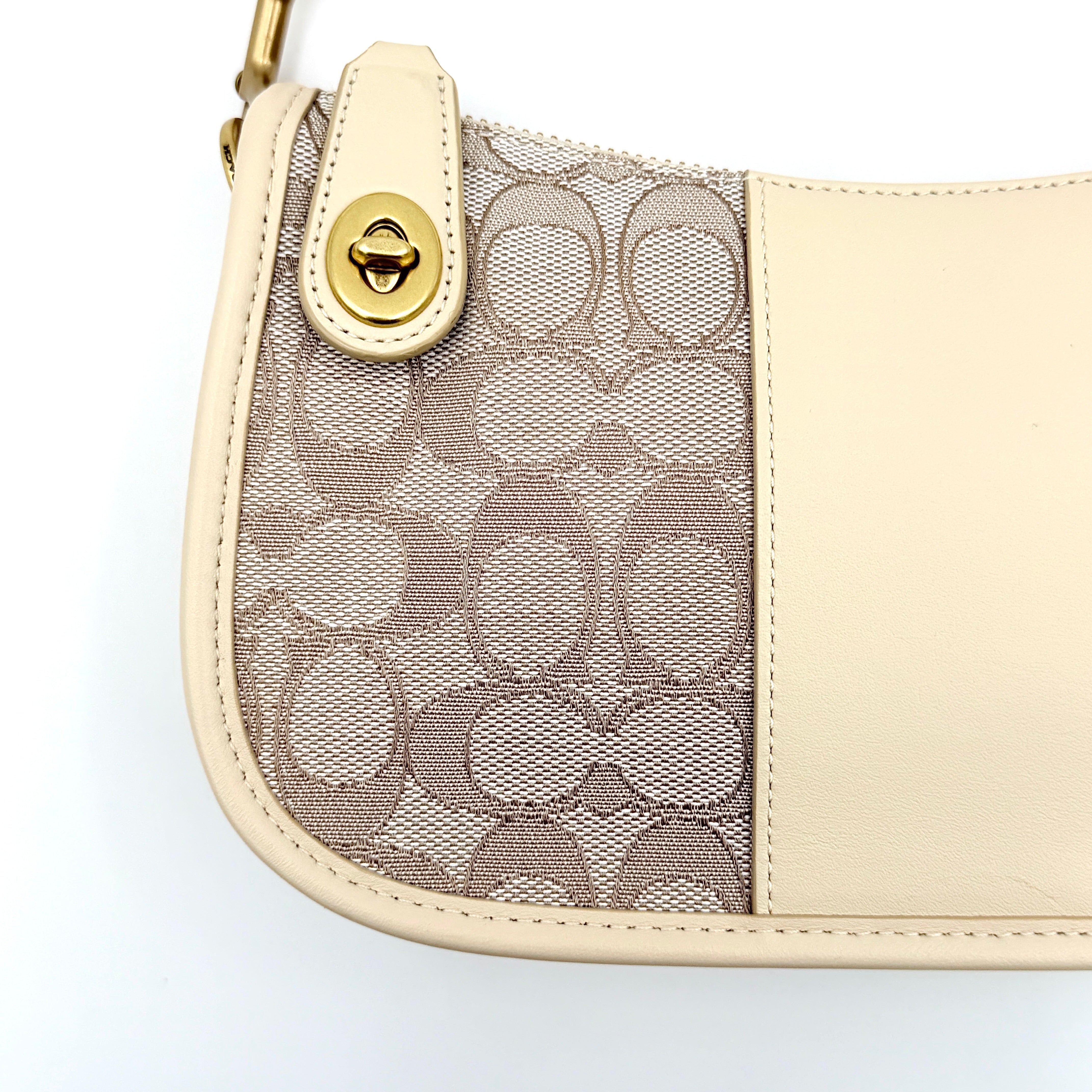 Coach Swinger 20 Stripe shoulder bag in grey and beige canvas with cream leather trim, shown with detachable strap and gold hardware.