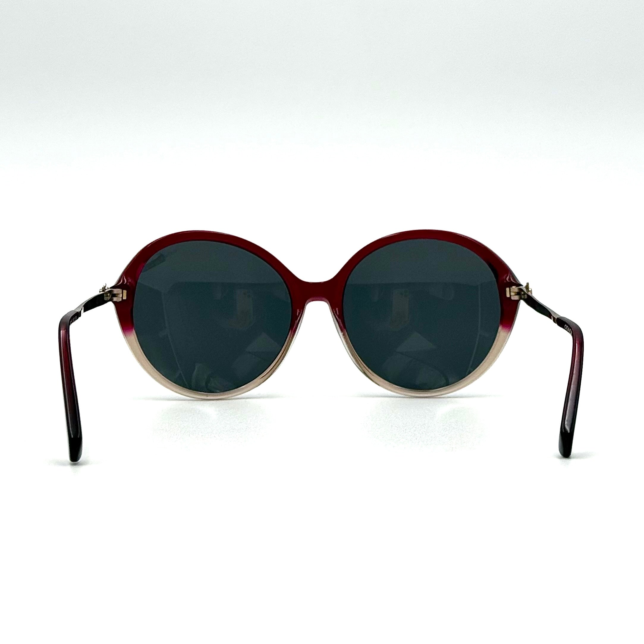 Coach HC8214F sunglasses in a red-to-sand gradient acetate frame with gold-tone metal temples and signature carriage detail.