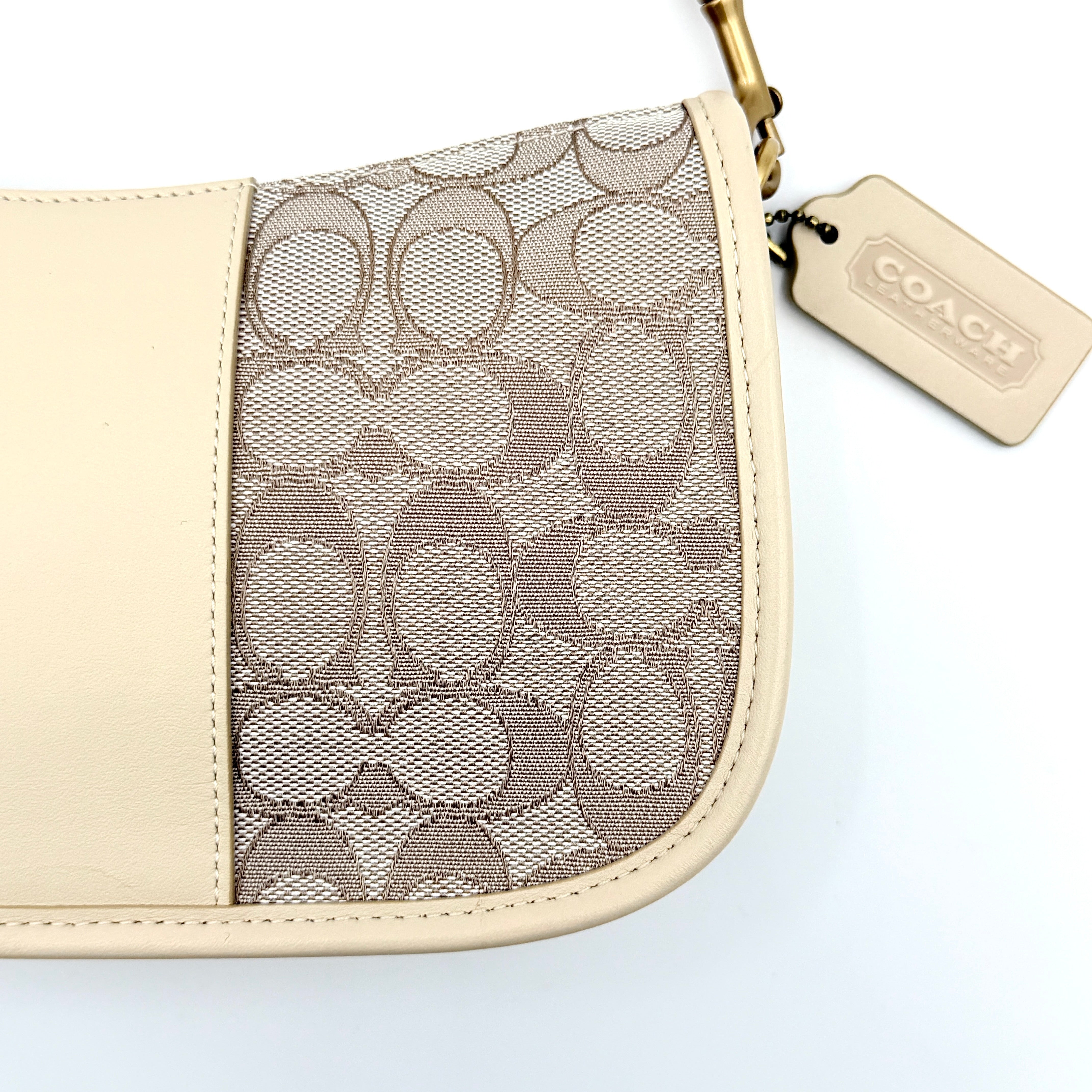 Coach Swinger 20 Stripe shoulder bag in grey and beige canvas with cream leather trim, shown with detachable strap and gold hardware.
