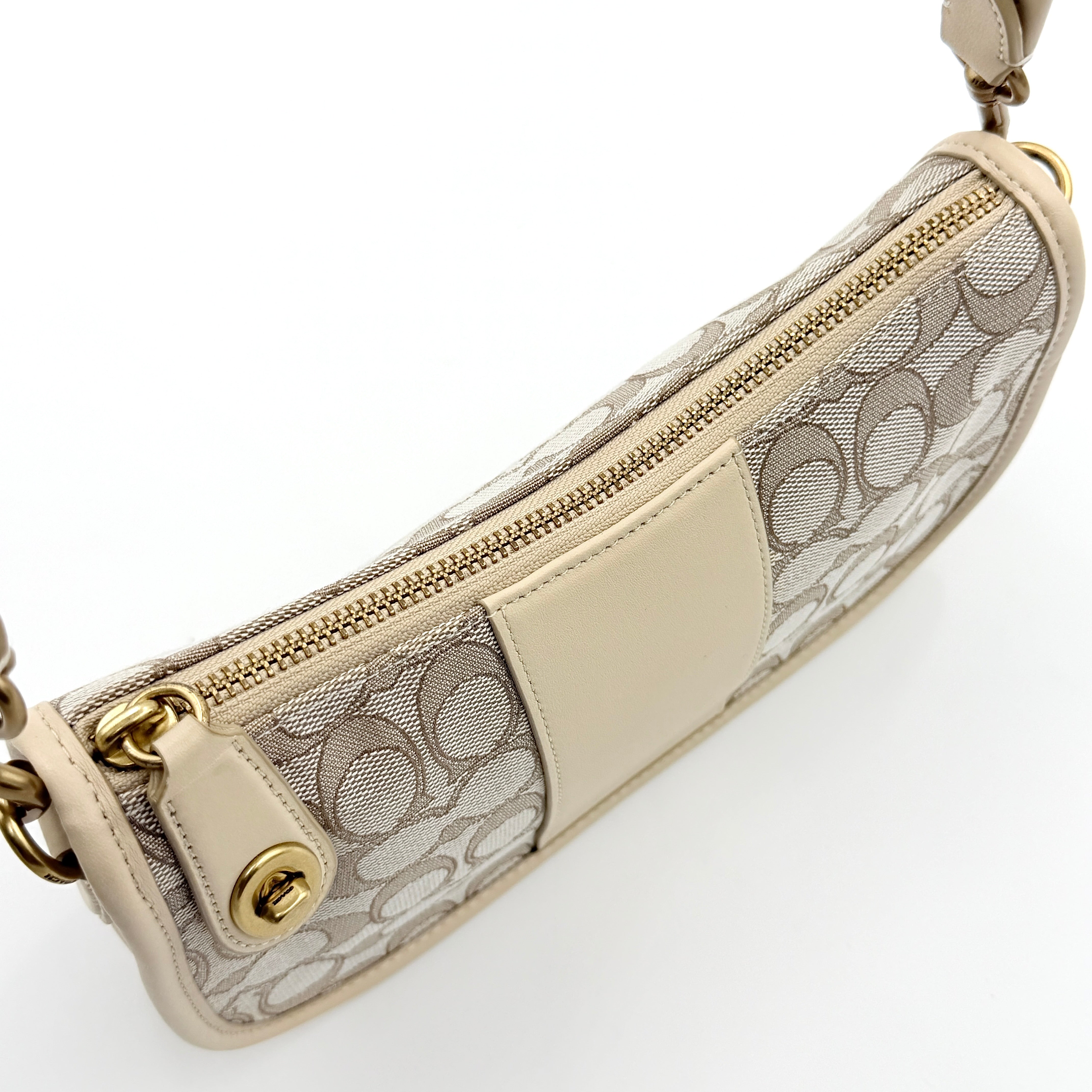 Coach Swinger 20 Stripe shoulder bag in grey and beige canvas with cream leather trim, shown with detachable strap and gold hardware.