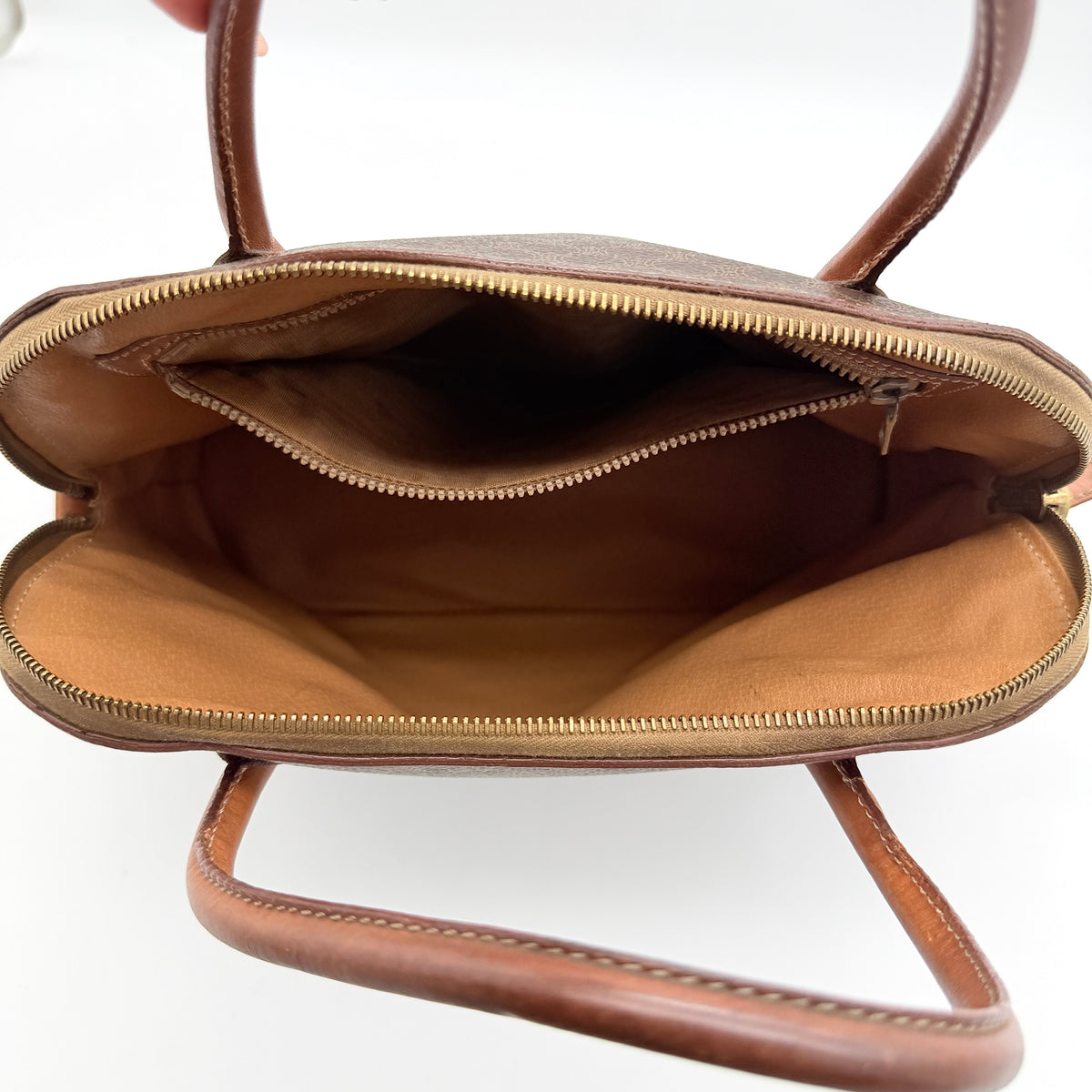 Celine Triomphe Macadam Dome Handbag in brown coated canvas with tan leather handles, shown against a white background.