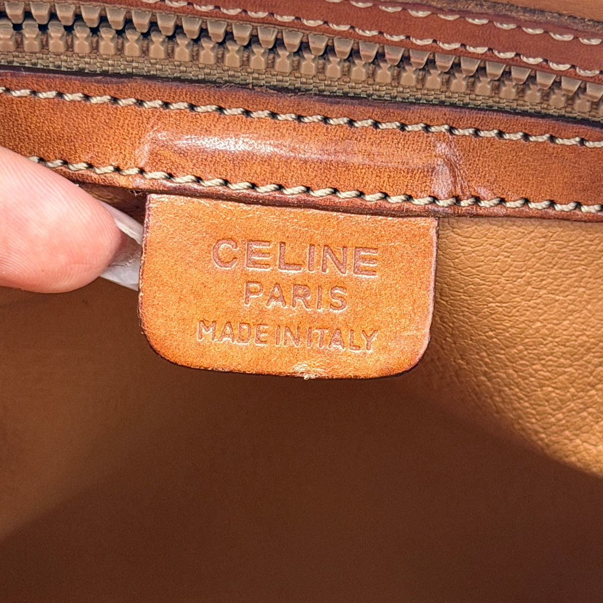 Celine Triomphe Macadam Dome Handbag in brown coated canvas with tan leather handles, shown against a white background.