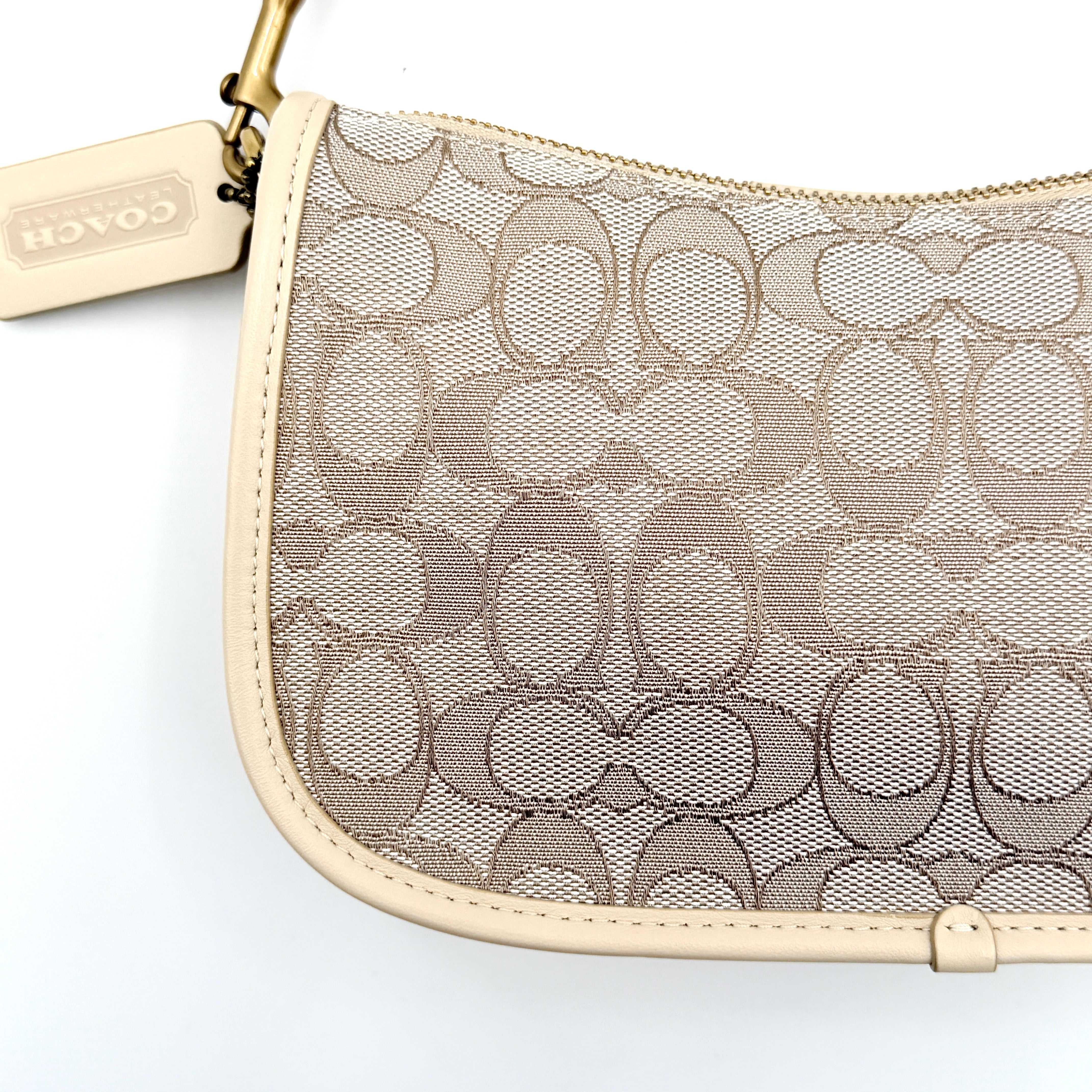 Coach Swinger 20 Stripe shoulder bag in grey and beige canvas with cream leather trim, shown with detachable strap and gold hardware.