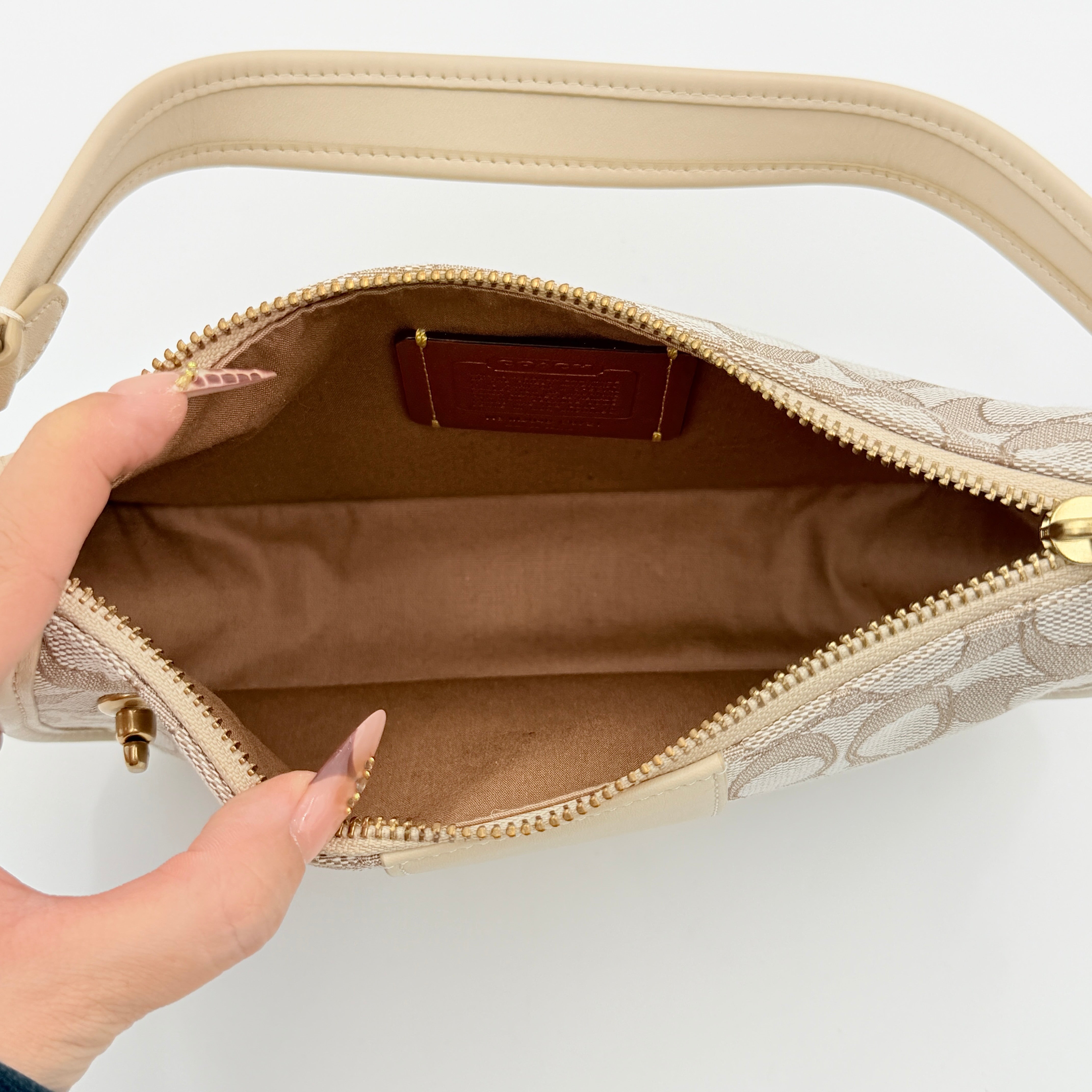 Coach Swinger 20 Stripe shoulder bag in grey and beige canvas with cream leather trim, shown with detachable strap and gold hardware.