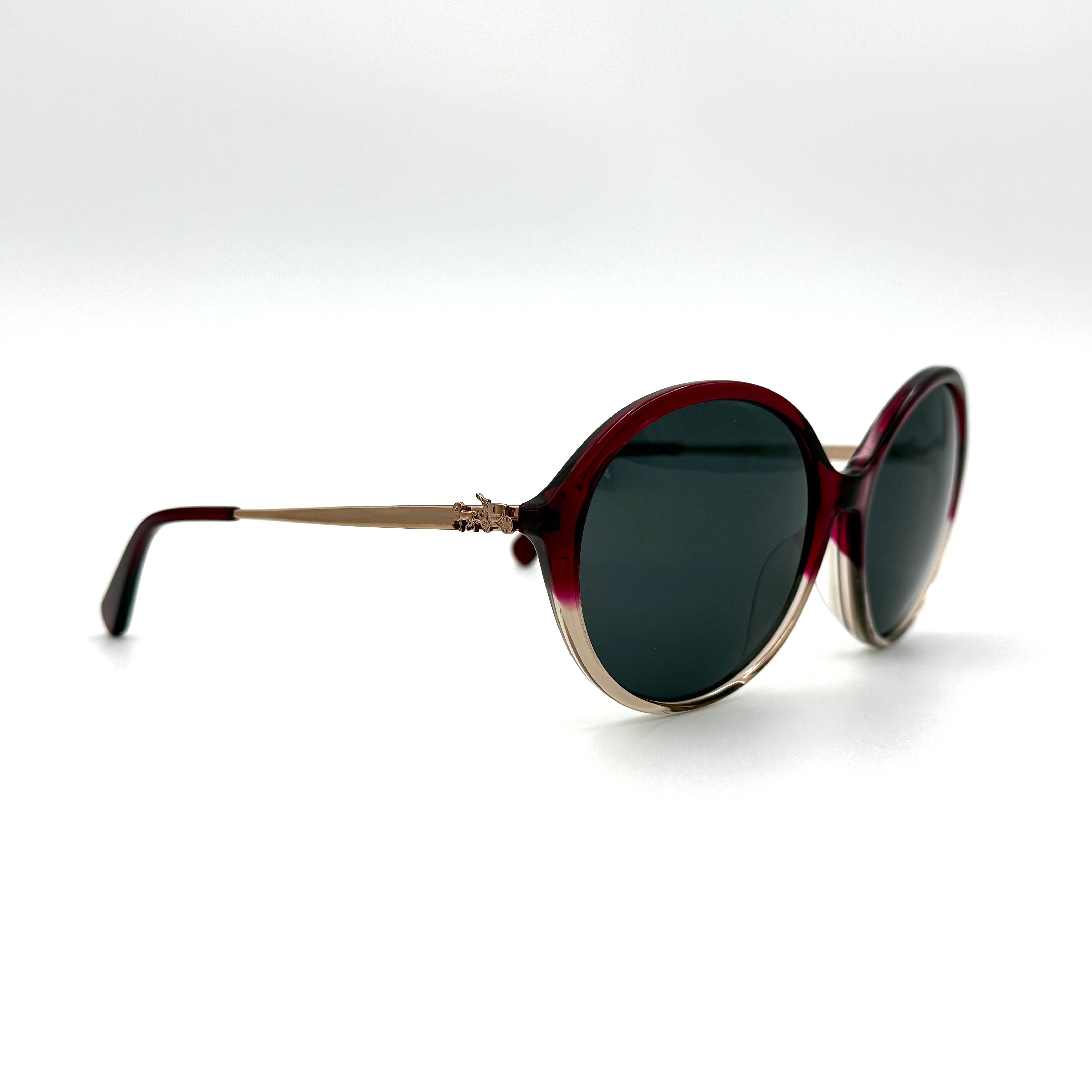 Coach HC8214F sunglasses in a red-to-sand gradient acetate frame with gold-tone metal temples and signature carriage detail.