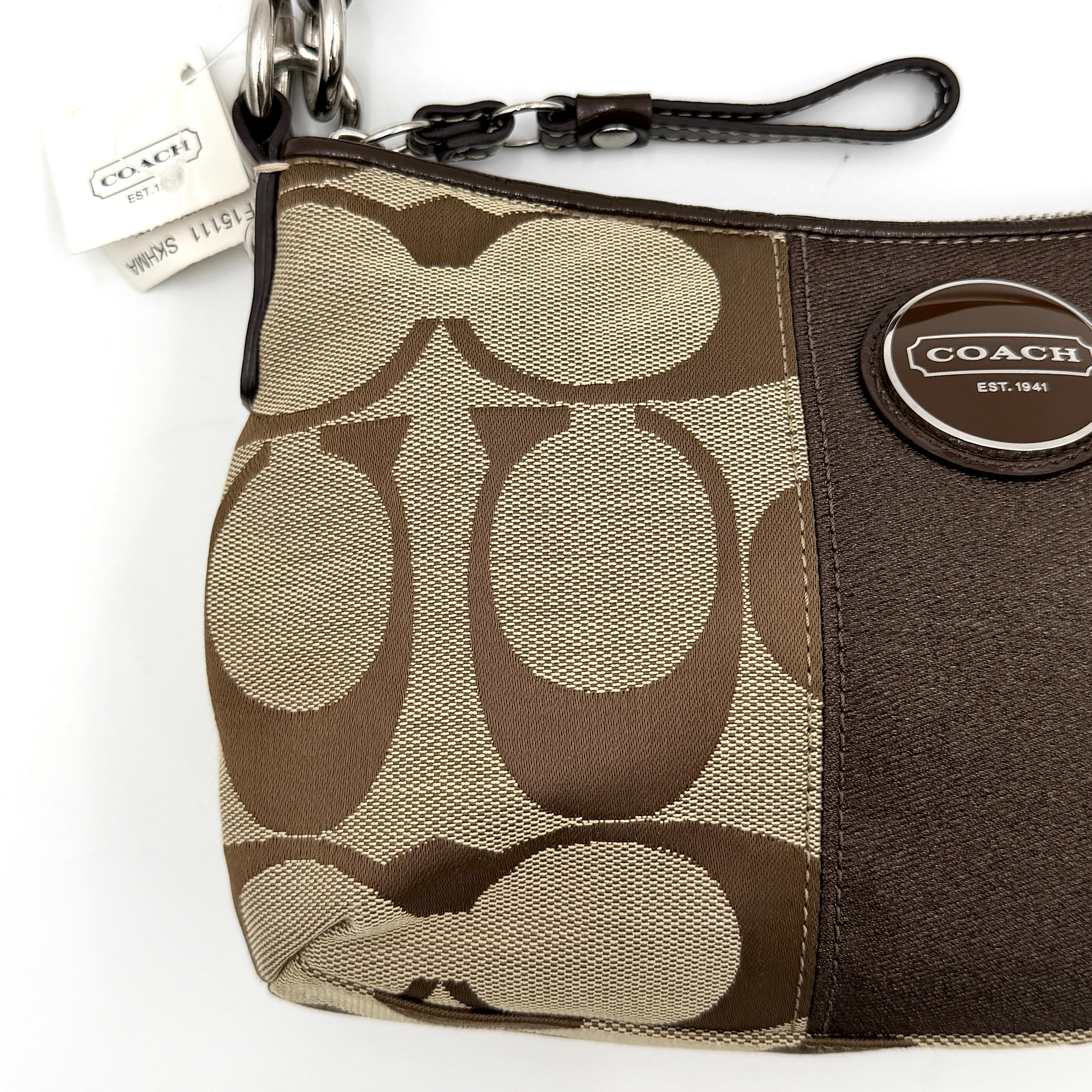 Coach khaki and mahogany signature jacquard shoulder bag with detachable strap and silver hardware displayed on a white background.